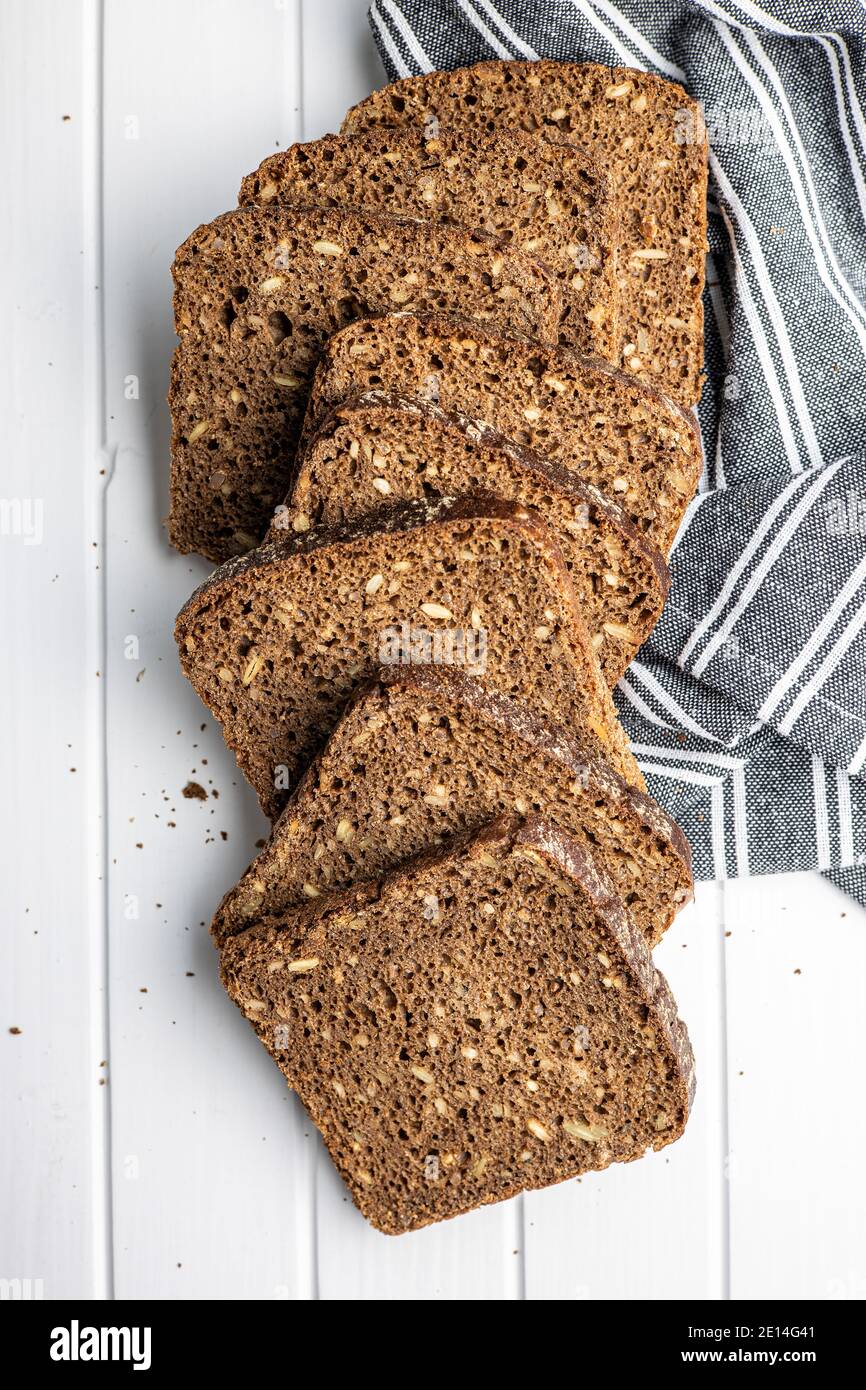 Dieting cereal bread with sunflower seeds on white table. Top view. Stock Photo