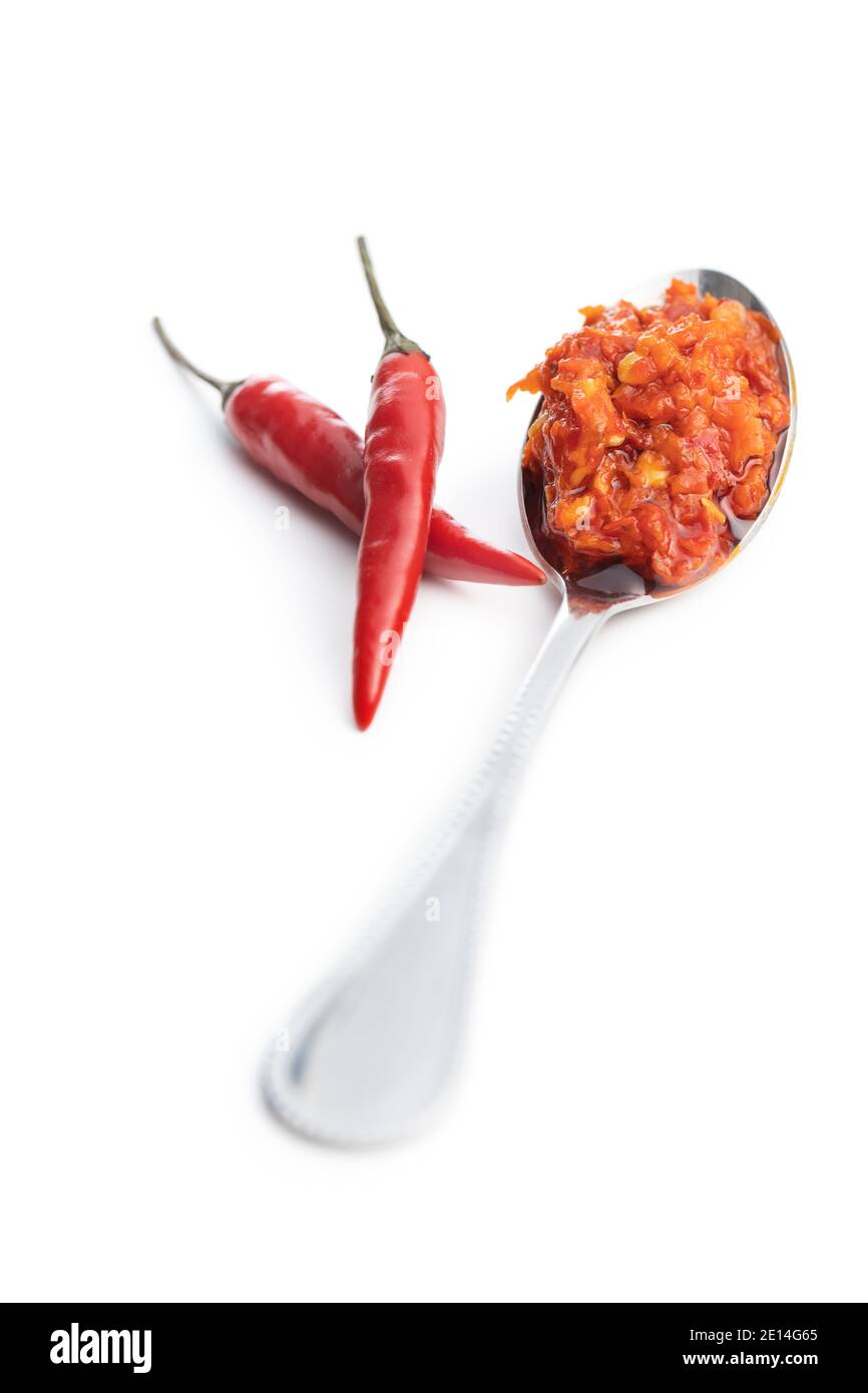 Red hot chili paste in spoon isolated on white background. Stock Photo