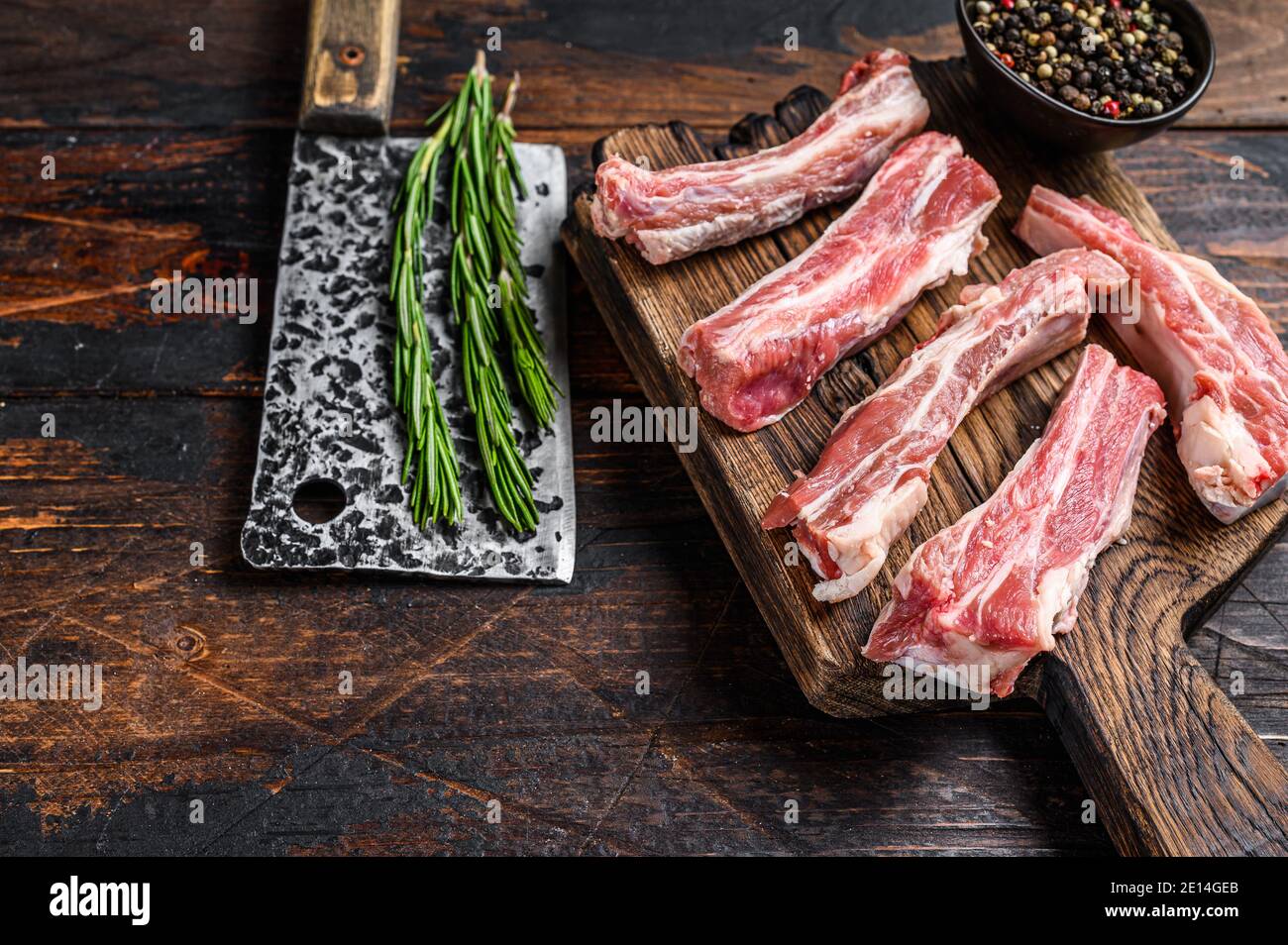 Raw sliced veal short spare loin ribs on a wooden cutting board. Black  background. Top view. Copy space Stock Photo - Alamy