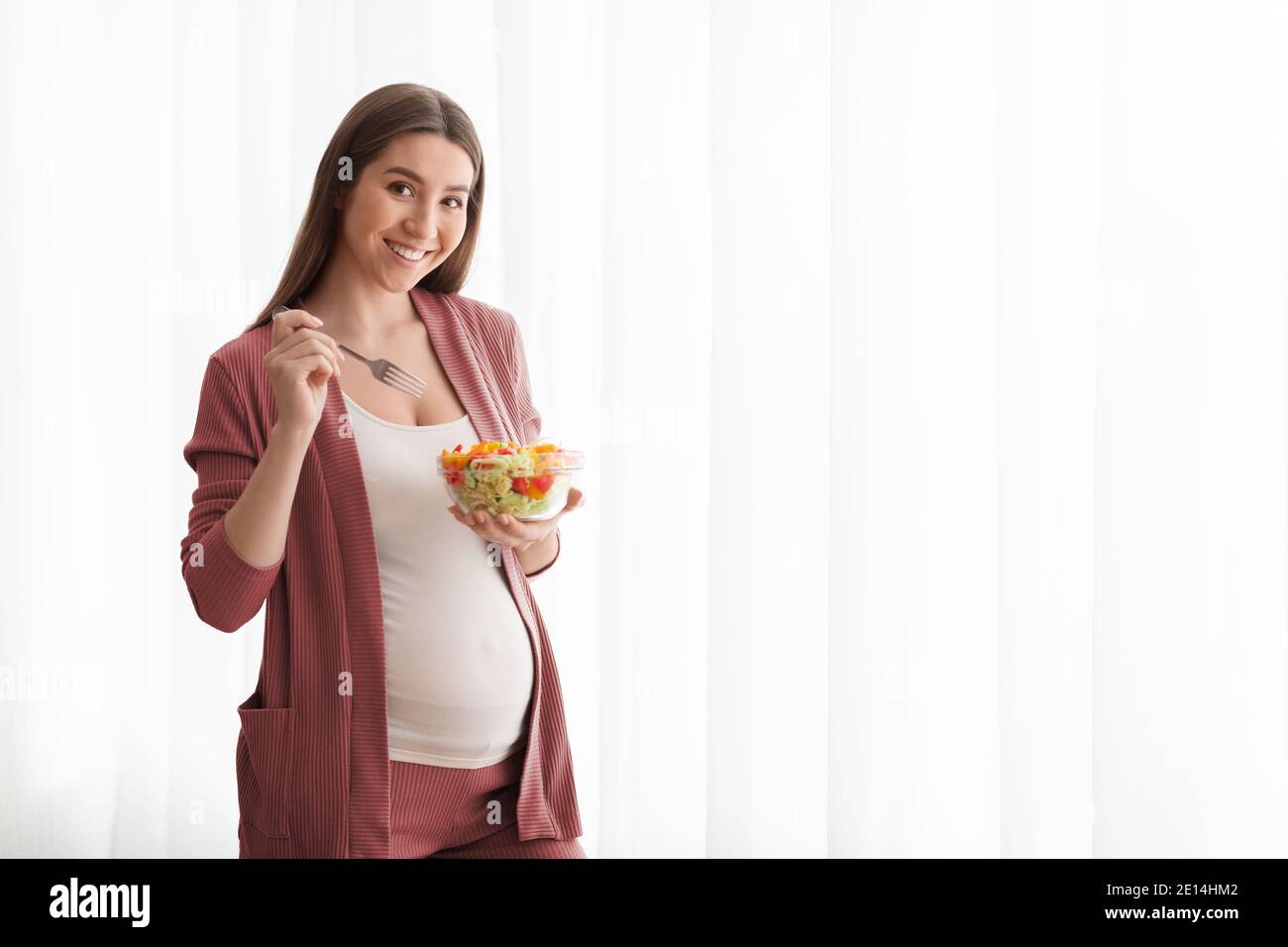 Nutrition During Pregnancy. Smiling Pregnant Lady Eating Fresh