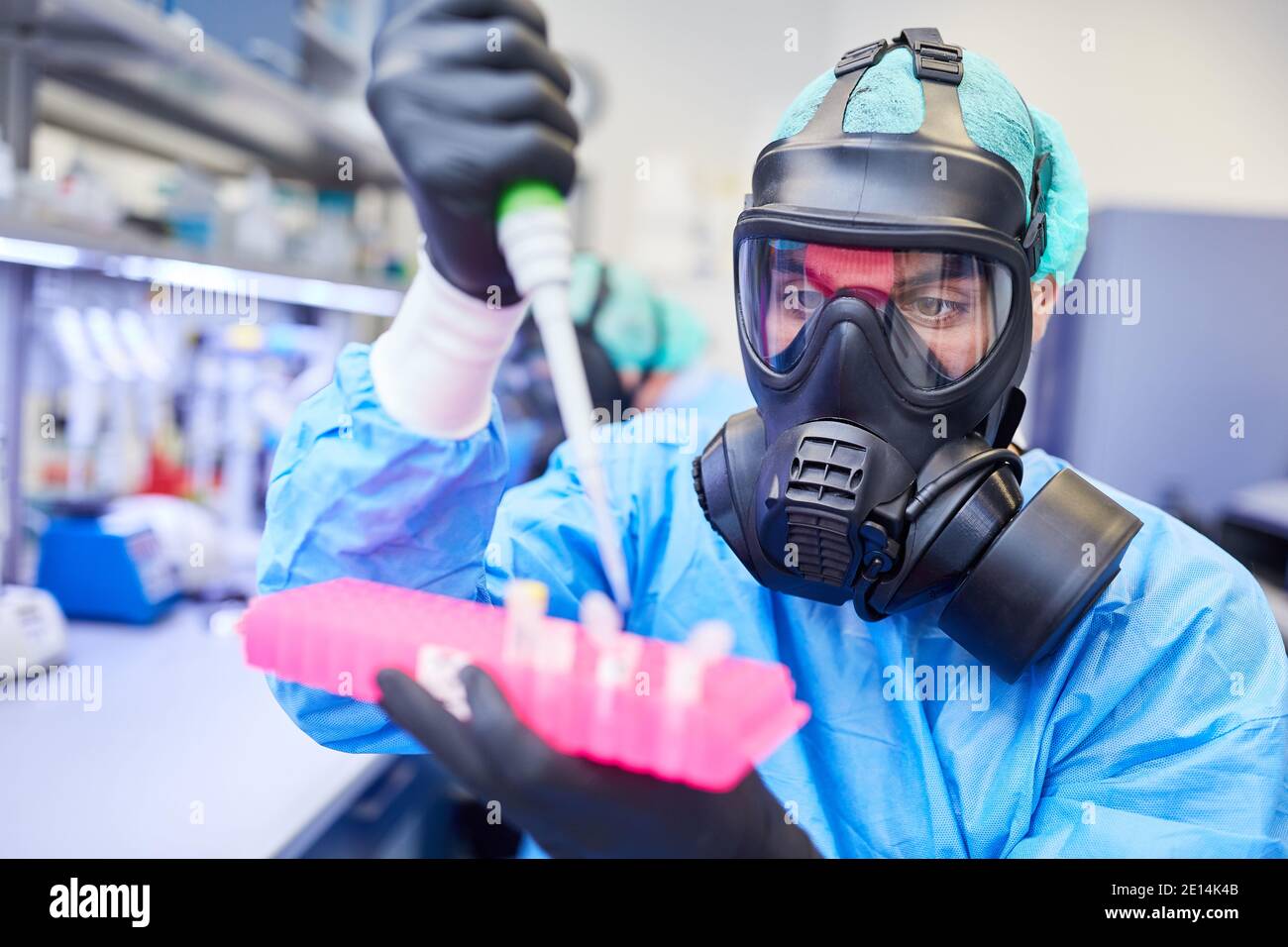 Researcher with full face mask works in the laboratory on Covid19