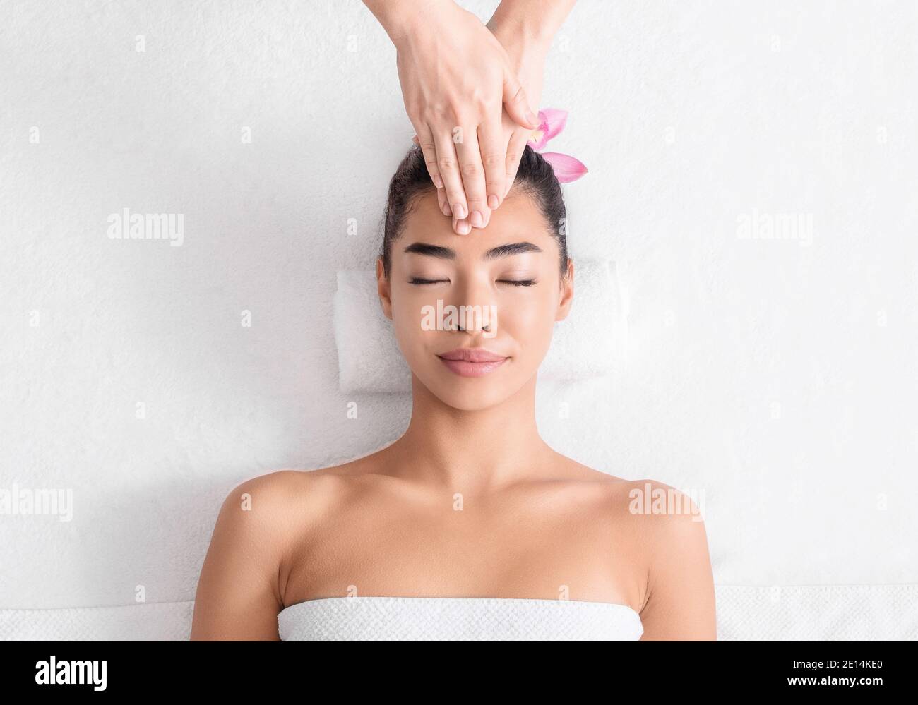 Portrait Of Beautiful Asian Lady On Acupressure Massage Therapy Session In Spa Stock Photo