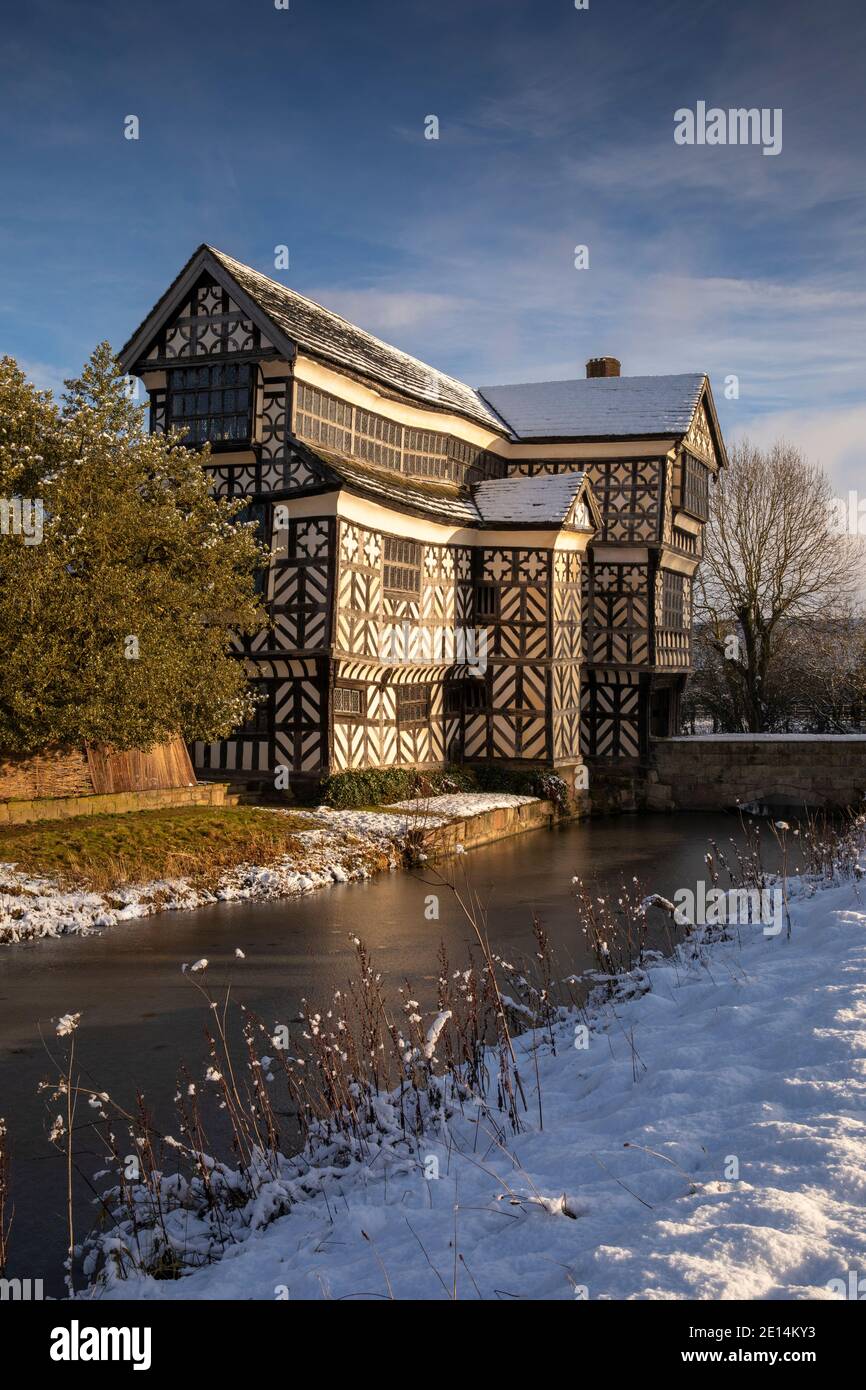 UK, England, Cheshire, Scholar Green, Little Moreton Hall, timber-framed Tudor Farmhouse, in winter, from moat Stock Photo