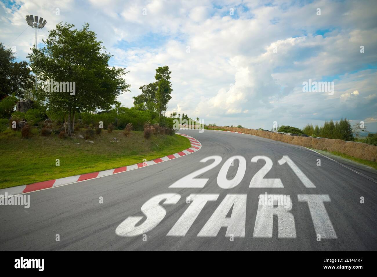 word 2021 start written on road of racetrack straight to mountain. New year 2021 or start straight concept. Concept of planning and challenge or caree Stock Photo