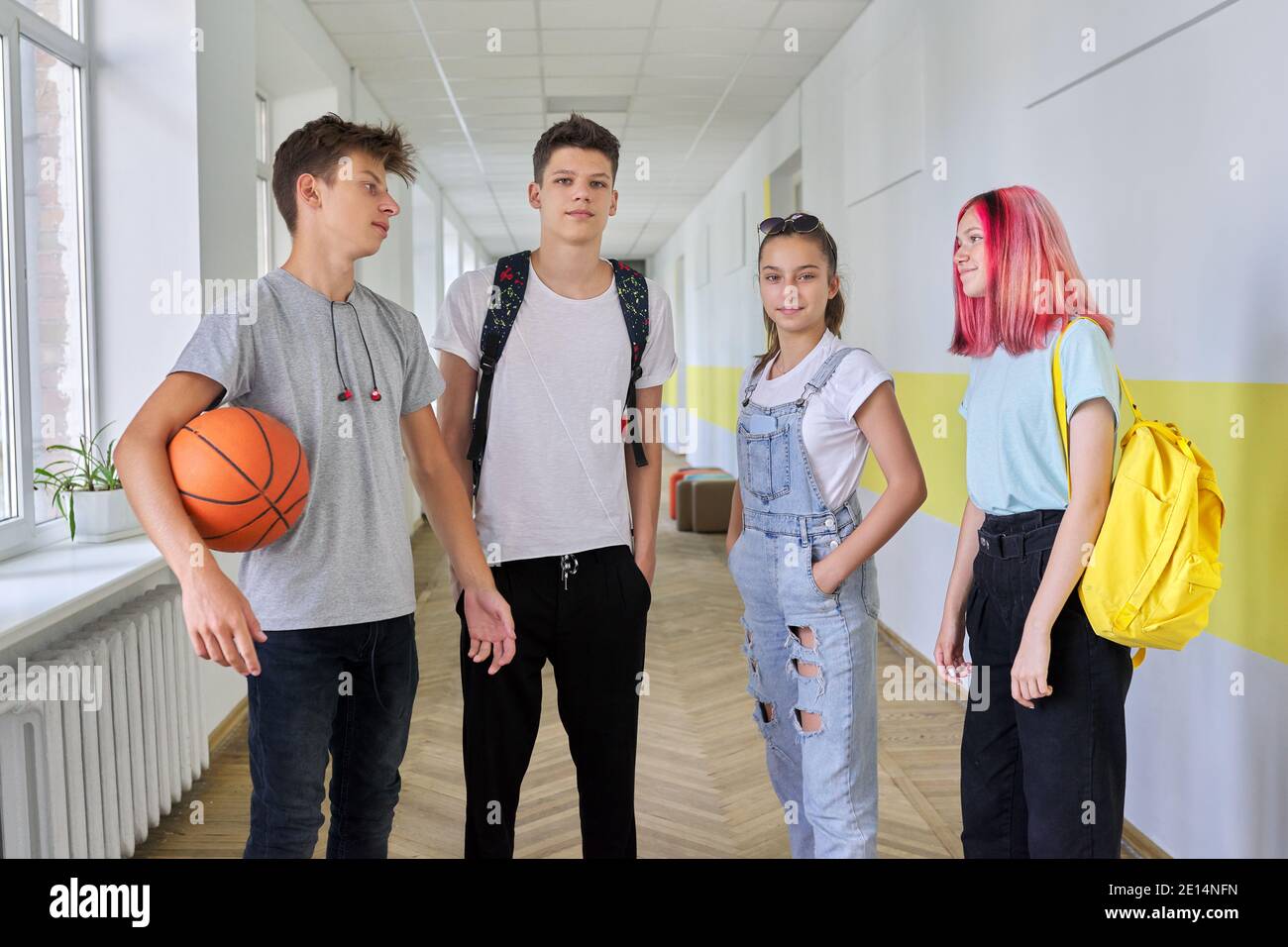 A group of teenage students 16 years old in the school hallway Stock Photo
