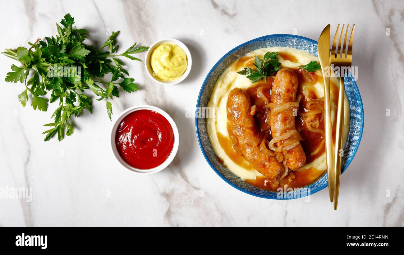 Traditional british dish bangers and mash of pork sausage with onion