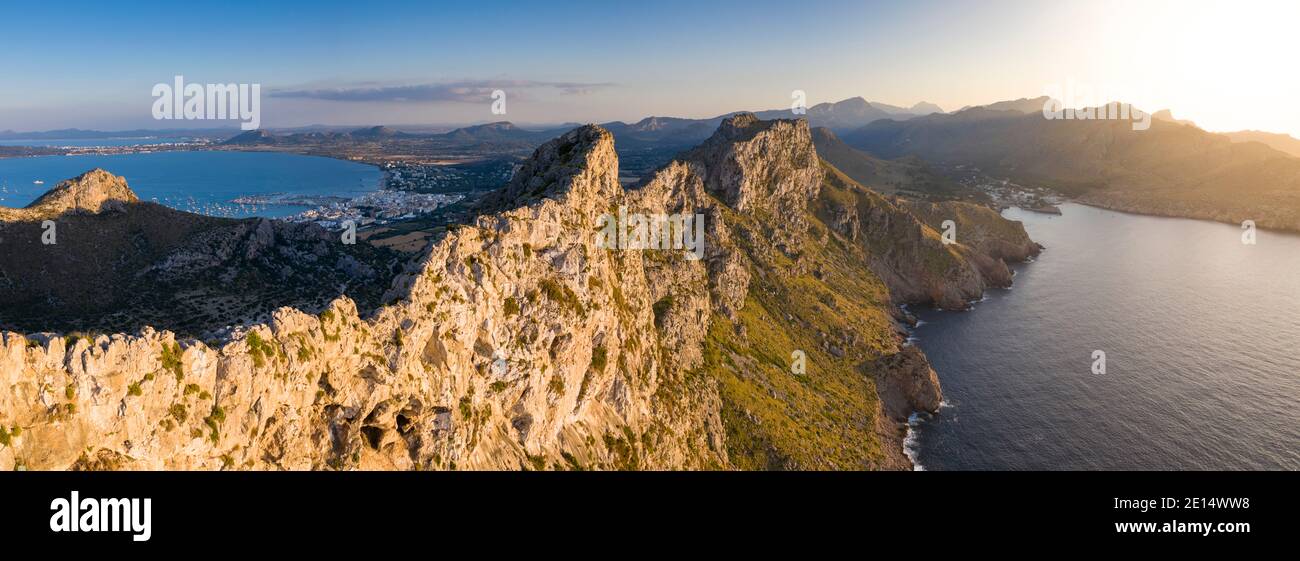 Aerial panoramic view along steep clifs of Cape Formentor at sunset, with Port de Pollença and Cala Sant Vicenç in background, Mallorca, Balearic Isla Stock Photo