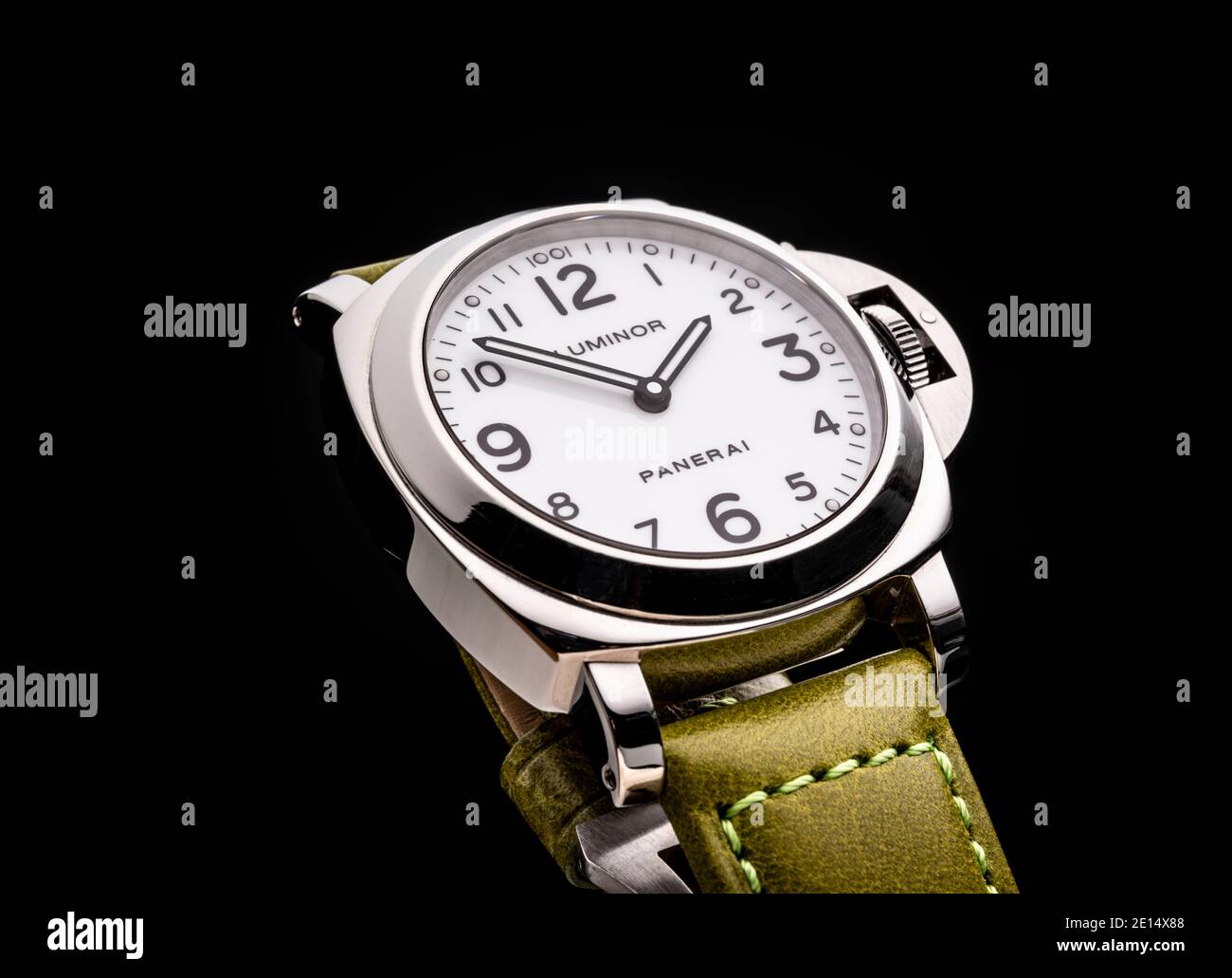 A luminor Officine Panerai Watch with green strap photographed on a black background. Stock Photo