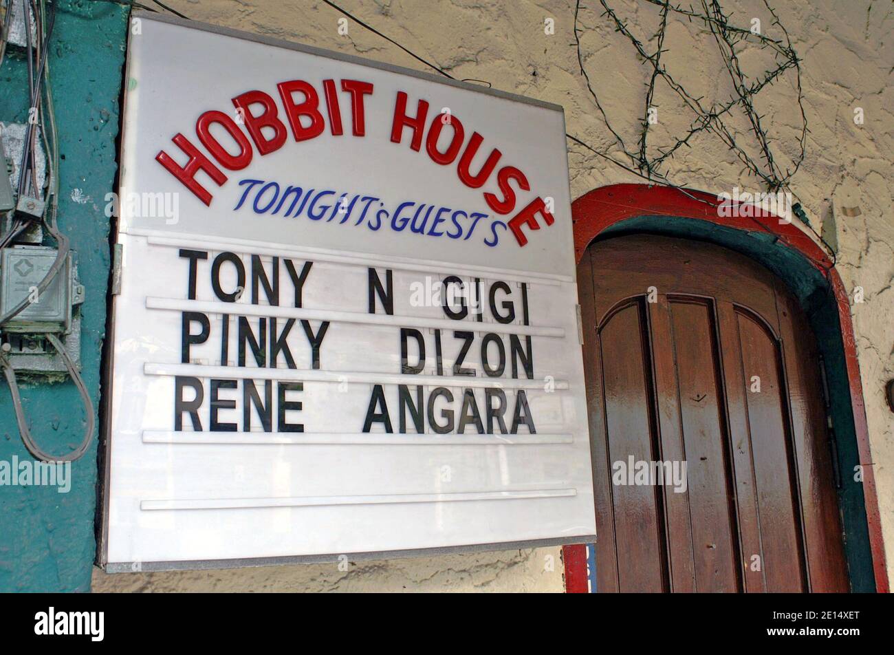 The Hobbit House, opened in 1973, is a Tolkien-inspired restaurant and bar known for its theme which includes 'small people' employees.  Originally located on Mabini Street in the Ermita District of Manila, the establishment was opened by Jim Turner, a Peace Corps Volunteer from Iowa, who recruited small people, or politically incorrectly called dwarfs, to run the establishment.  The Hobbit House eventually moved to M.H. del Pilar Street before shutting down.  The 2005 photo is of the Hobbit House outside sign, on Mabini Street, advertising its entertainment for the evening. Stock Photo