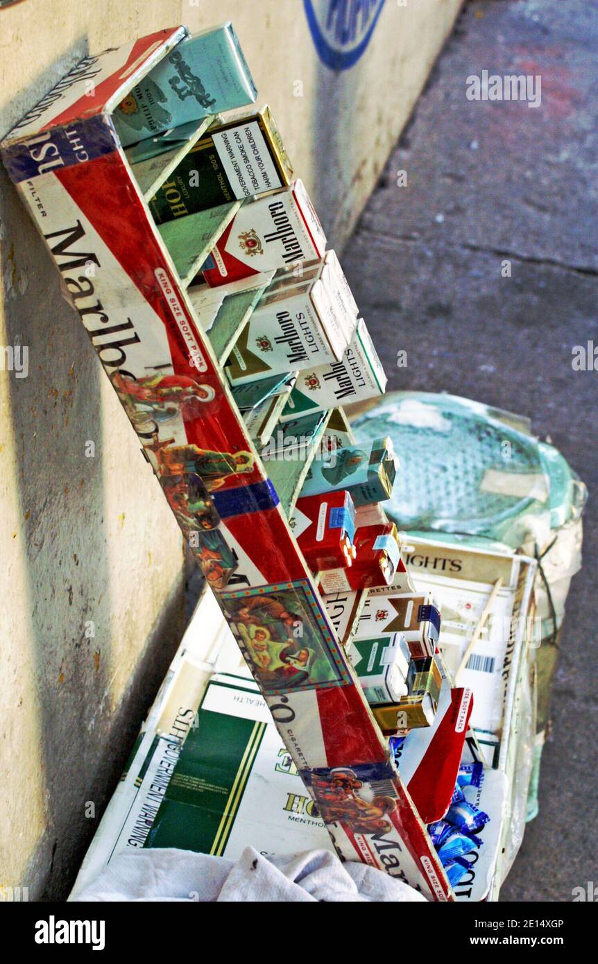 A street vendor's cigarette display holds varying pack and single