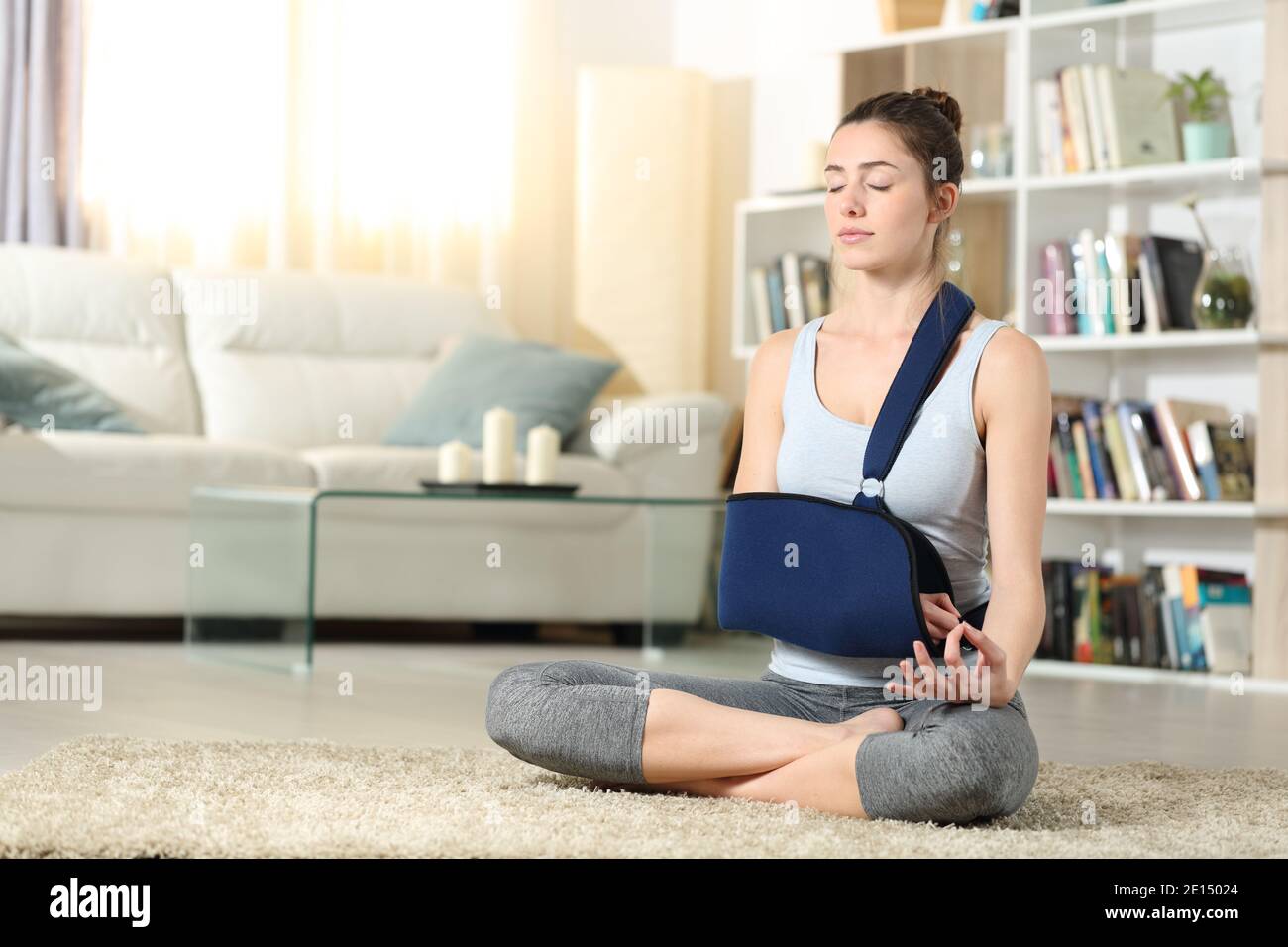 Full body portrait of a disabled woman with a broken arm in a sling