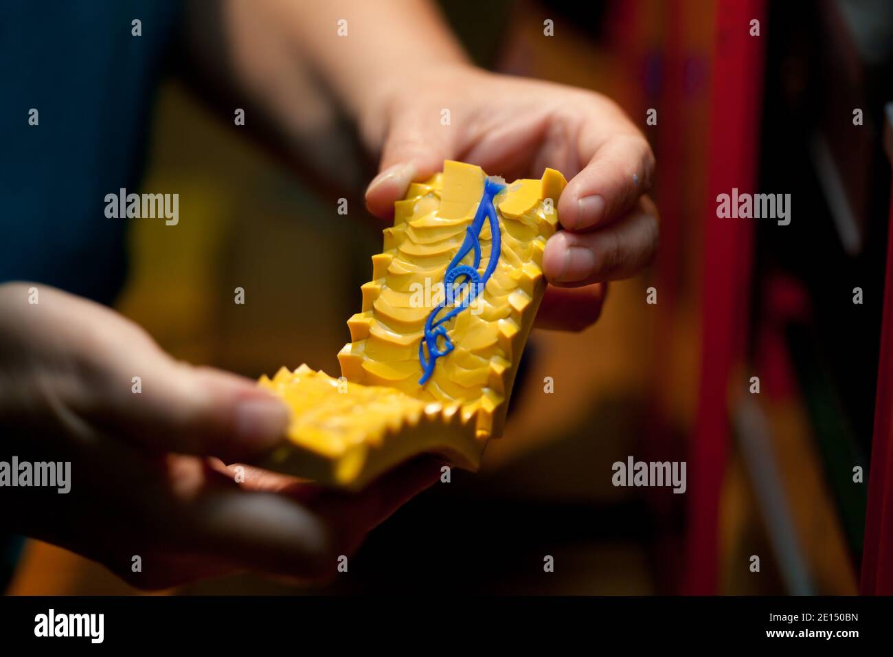 making jewelry, hands holding molds for casting golden jewelry parts