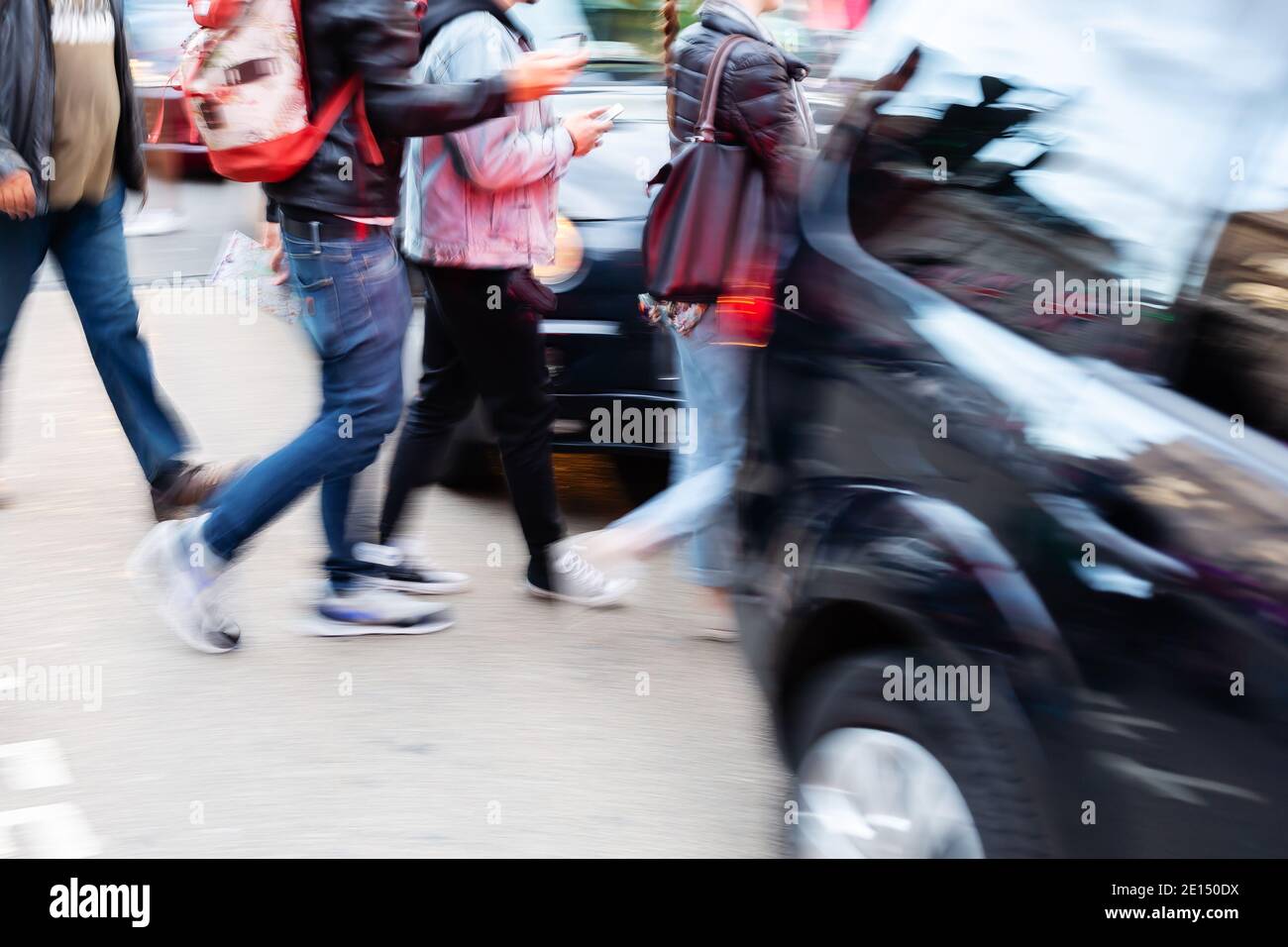 picture with camera made motion blur effect of people crossing a street ...