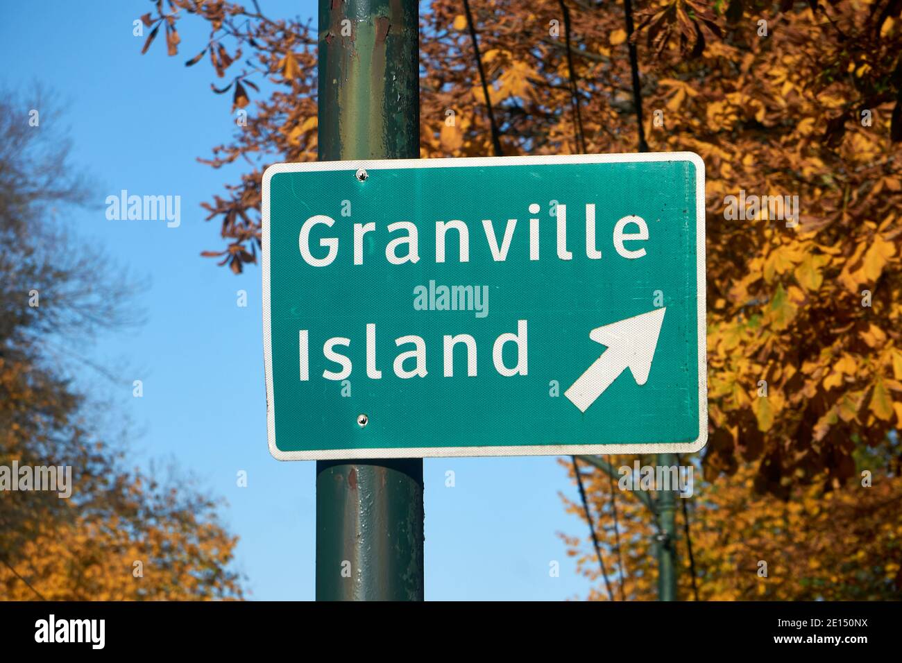 Road sign with arrow pointing direction to to Granville Island in Vancouver, British Columbia, Canada Stock Photo