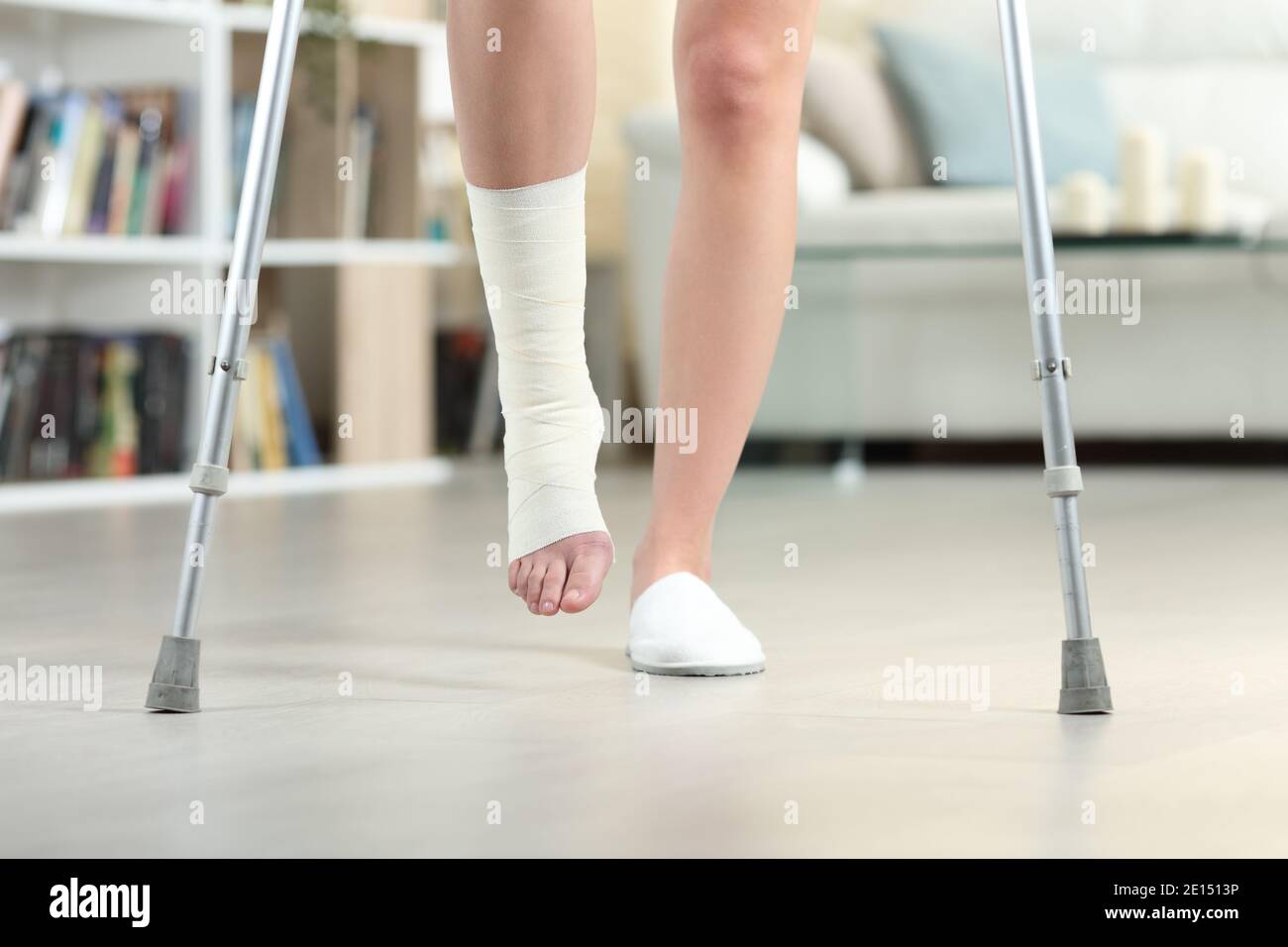Front view close up of a disabled woman walking with crutches and