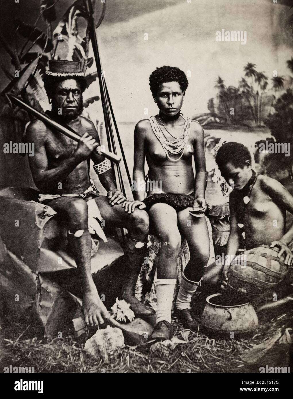 Vintage 19th century photograph - Oceania, Pacific Islands, probably Fiji,  Tahiti or Western Samoa: man with club (and his wives Stock Photo - Alamy