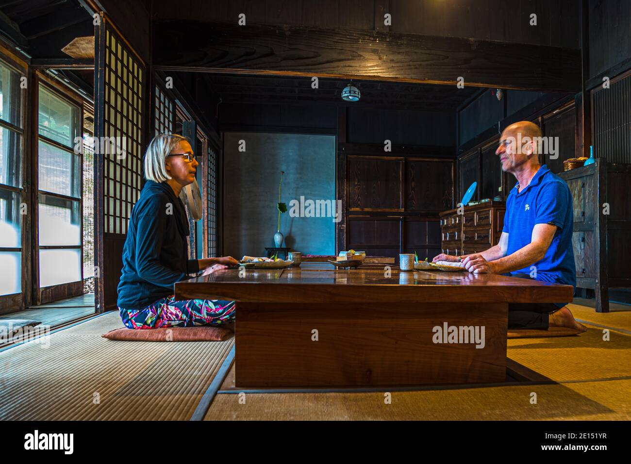 Photographer Georg Berg is sitting with Angela Berg at a low table during a kaiseki dinner in the traditional farmhouse of the Rakan kaiseki restaurant, run by chef Atsuko Kato, on the Izu Peninsula, Japan. Stock Photo