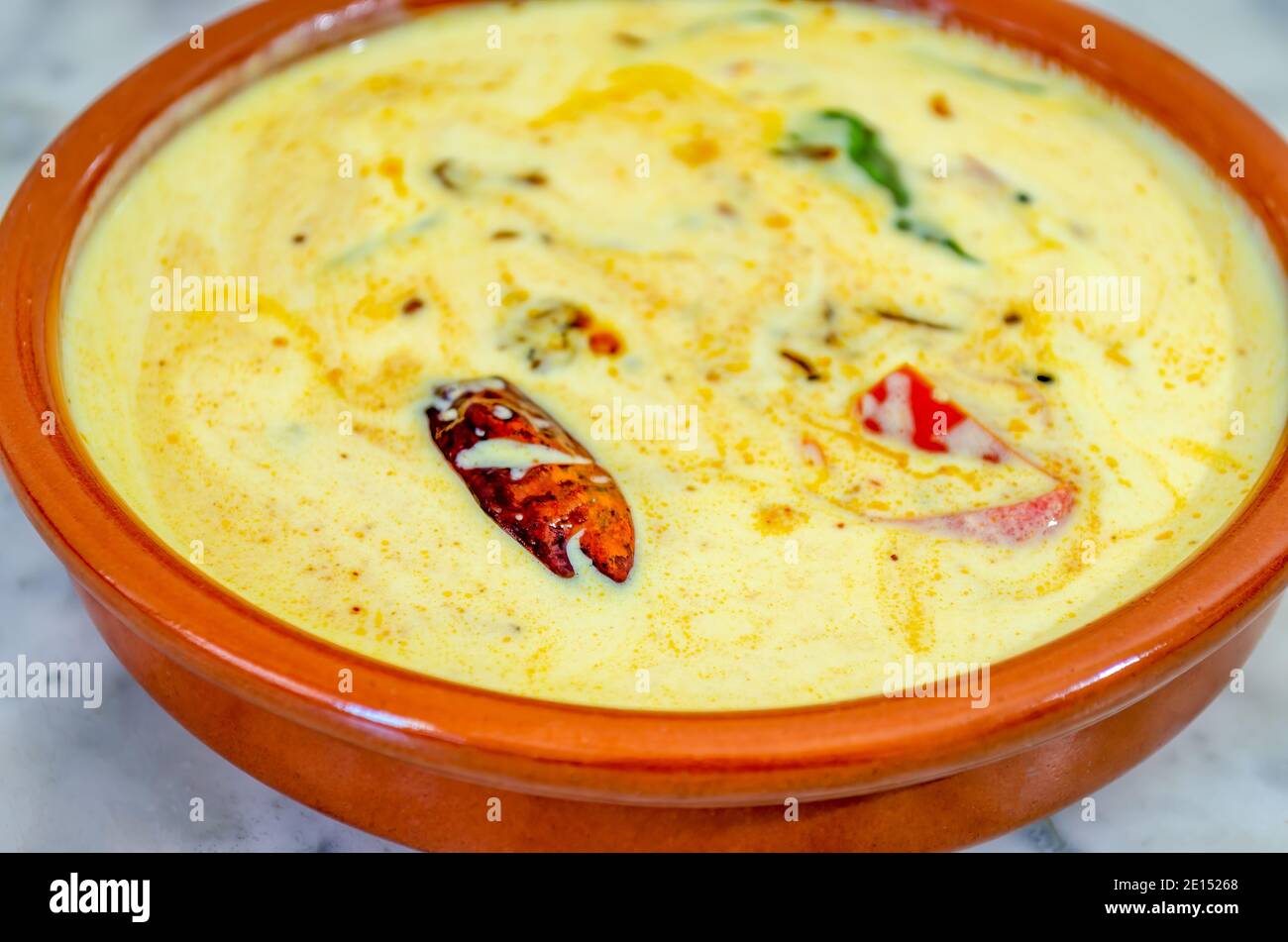 Closeup shot of Tomato Buttermilk Curry in an clay bowl Stock Photo