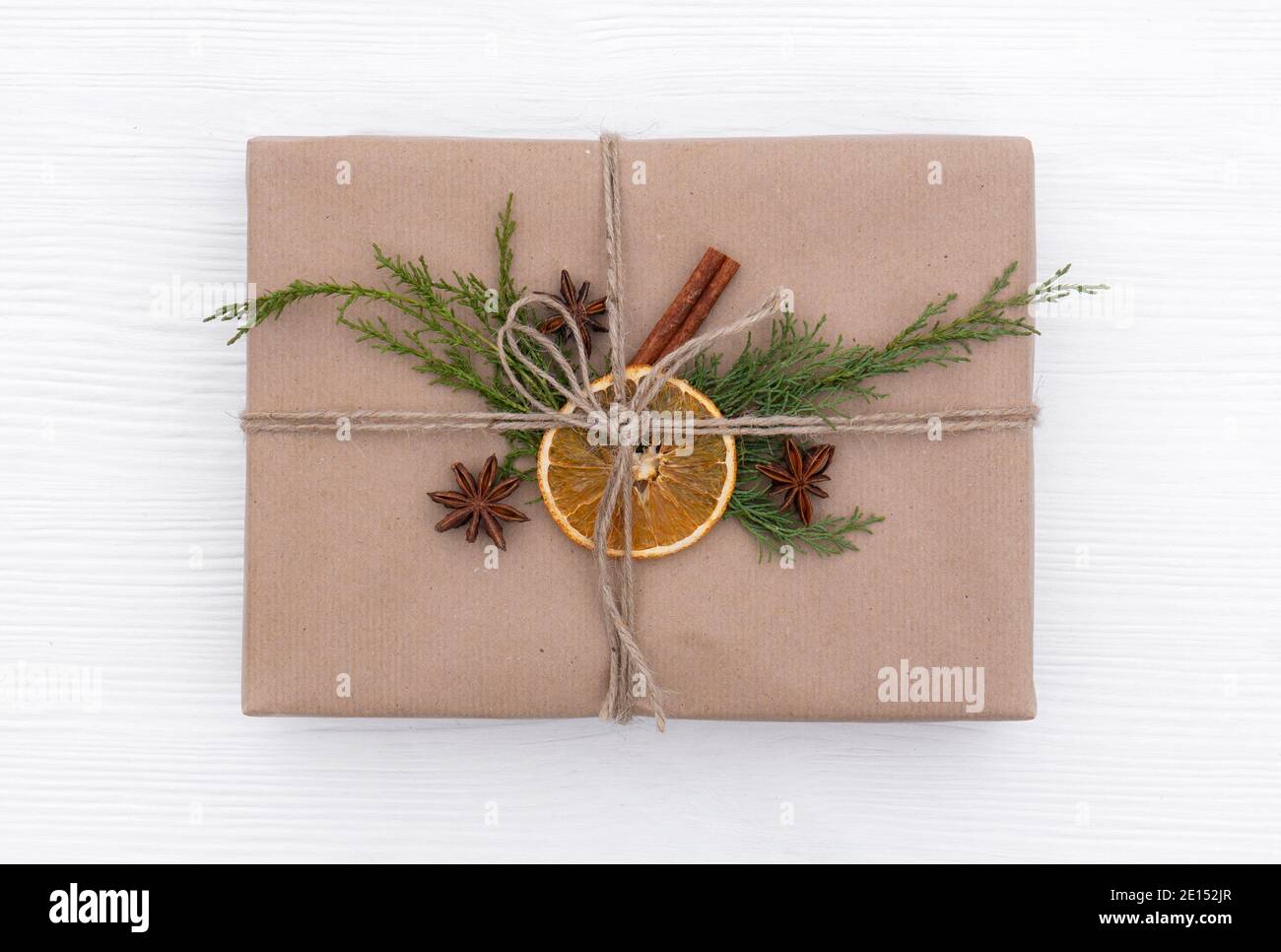 An Original Way Of Wrapping Christmas Gifts Using Craft Paper, Jute Rope,  Spruce Twigs, Oranges And Spices. Top View Of A Beautiful Gift In A  Scandina Stock Photo - Alamy