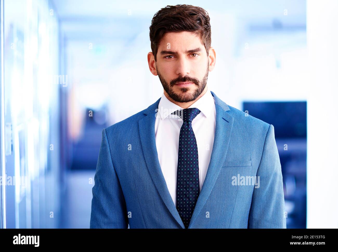 Studio portrait of handsome young businessman wearing suit and tie ...