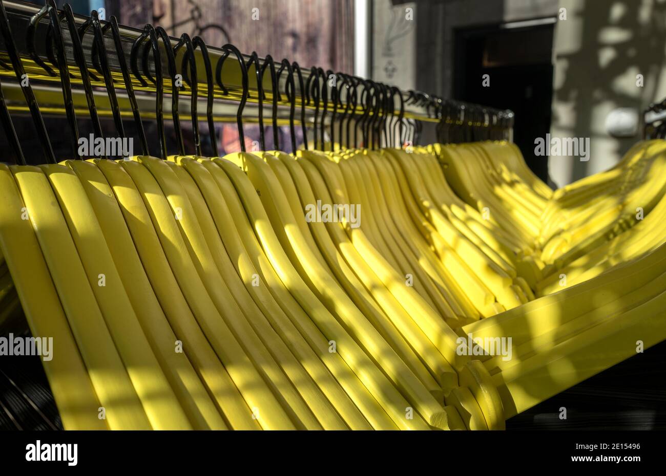 Yellow Wooden Hangers At A Wardrobe Stock Photo