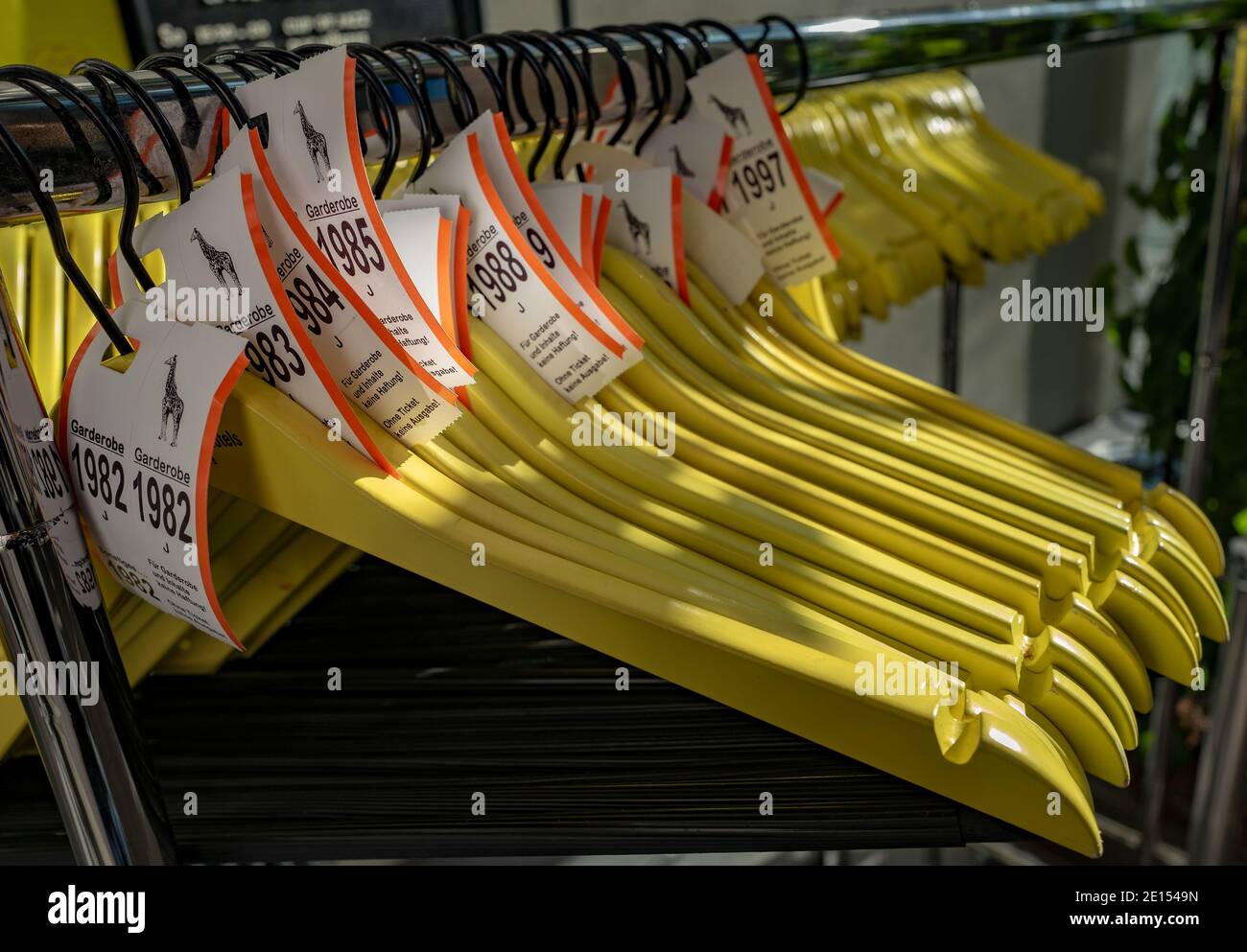 Yellow Wooden Hangers At A Wardrobe Stock Photo