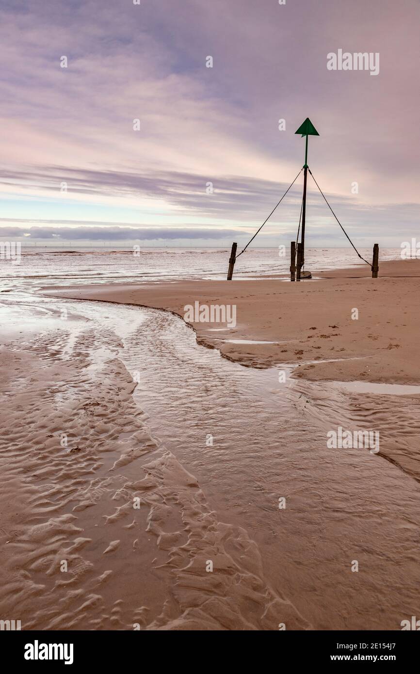 Marker post on Prestatyn Beach, North Wales Stock Photo