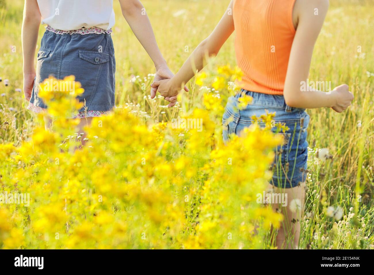 Friendship symbol, kids girls holding hands walking forward together ...