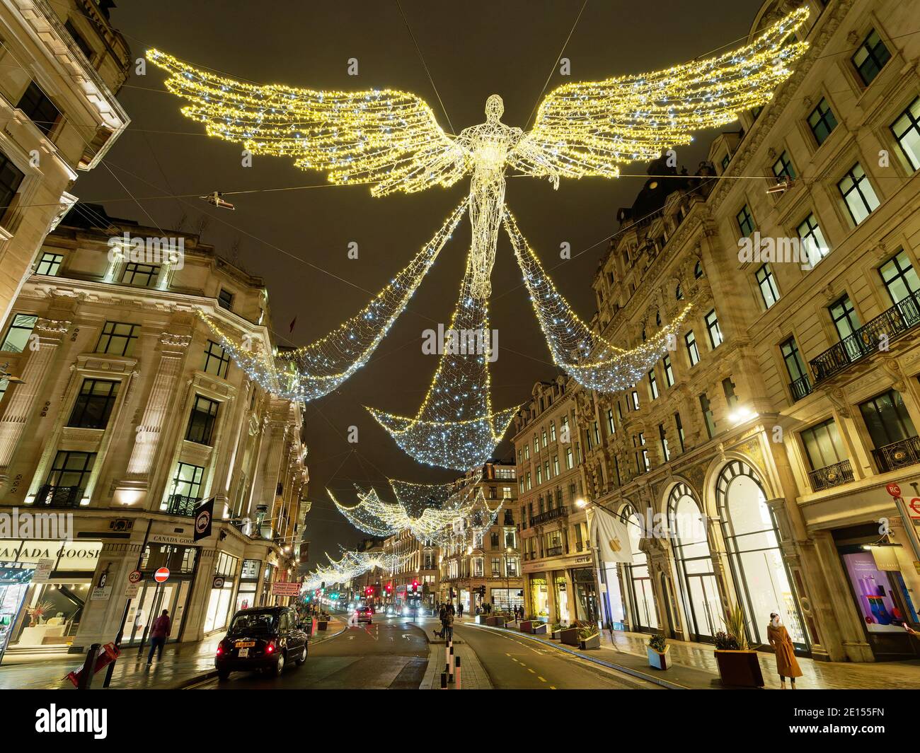 View looking up at the festive Christmas decorations at night in Regent Street London 2020 Stock Photo