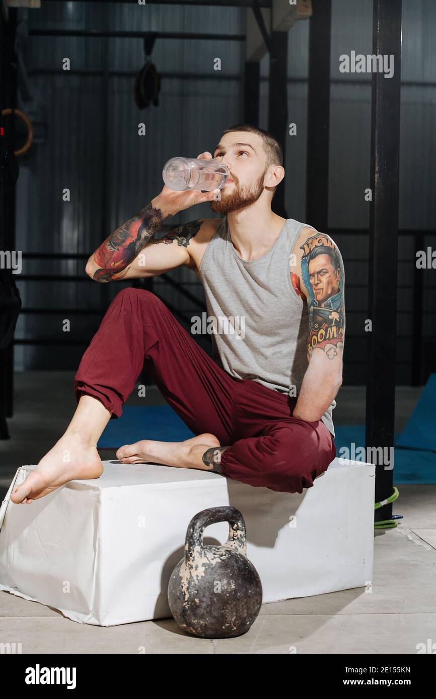 Happy young man drinking water after workout outdoors stock photo (124775)  - YouWorkForThem