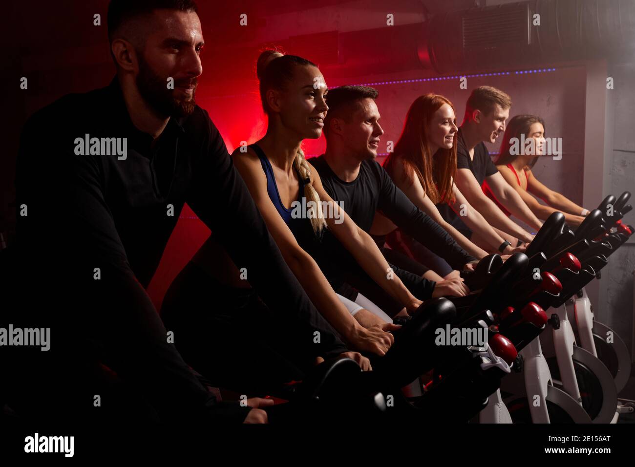 fit people exercising and working out in gym, cycling machine bicycle