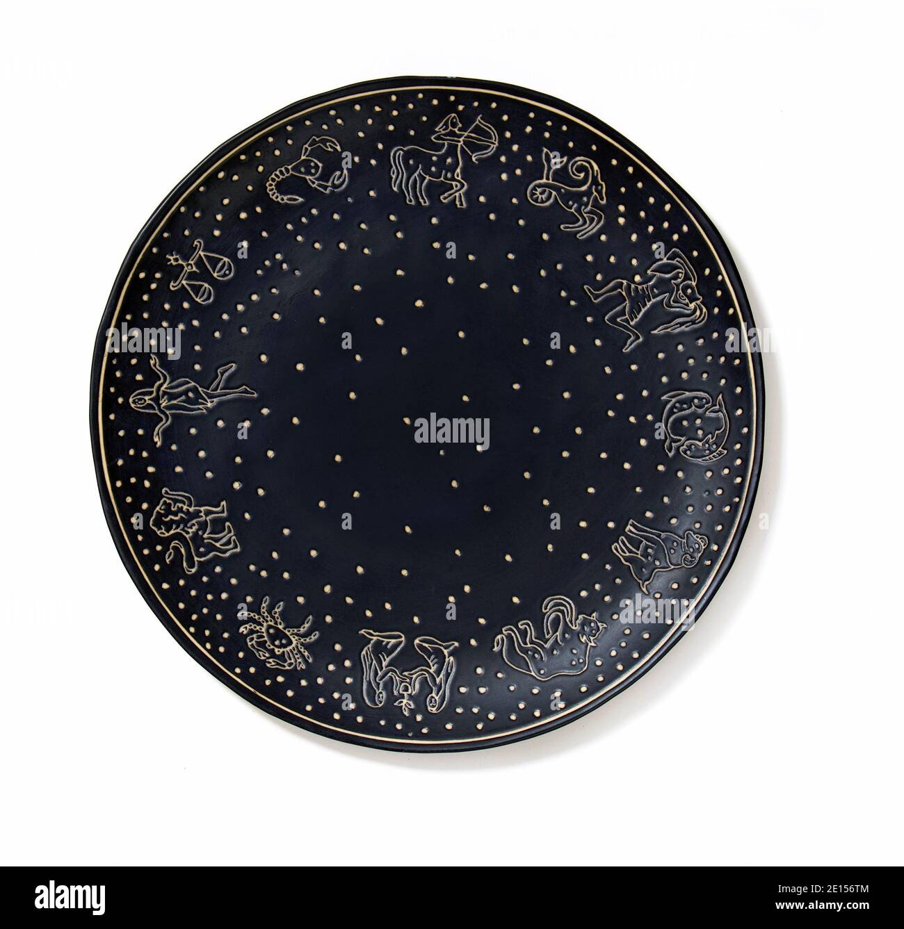 Black and gold astrology serving plate ED by Ellen fashion line by Ellen Degeneres photographed on a white background Stock Photo