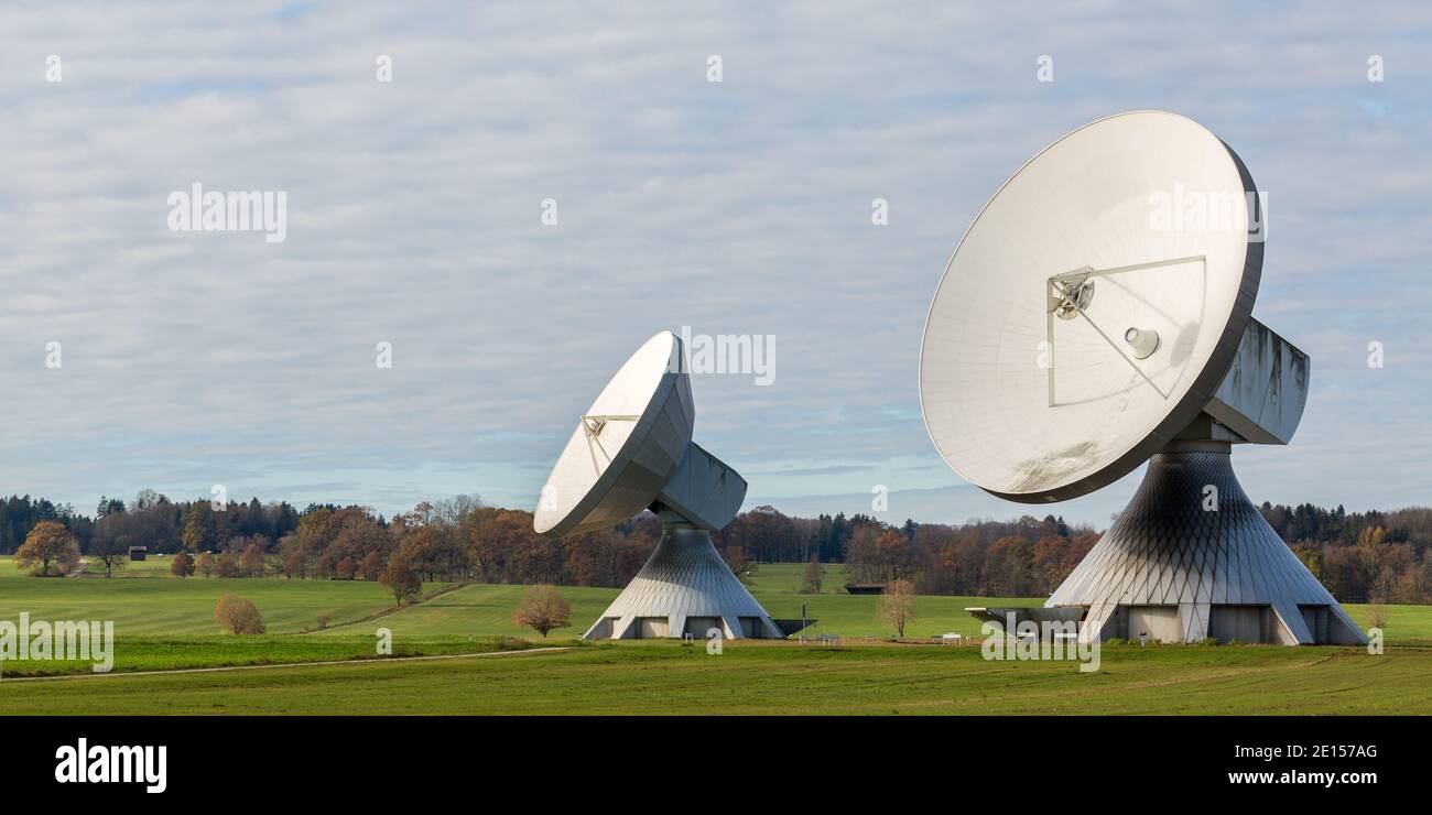 Raisting, Germany - Nov 13, 2020: Panorama photo with two huge satellite dishes in upper bavarian landscape. Earth station for satellite communication Stock Photo