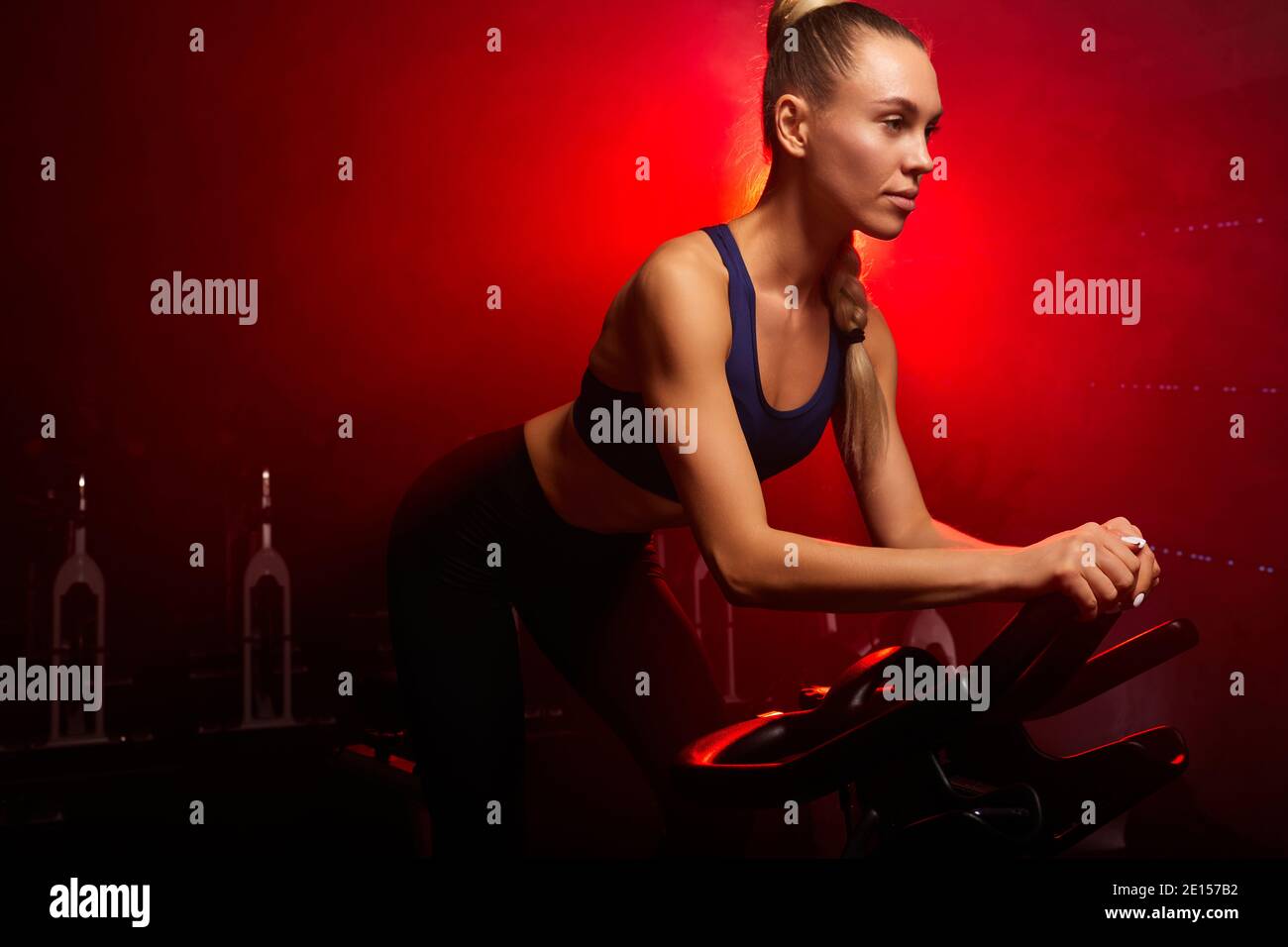 Side view of slim ladies in sportswear training on modern bicycle machines  in modern gym having cardio workout Stock Photo - Alamy