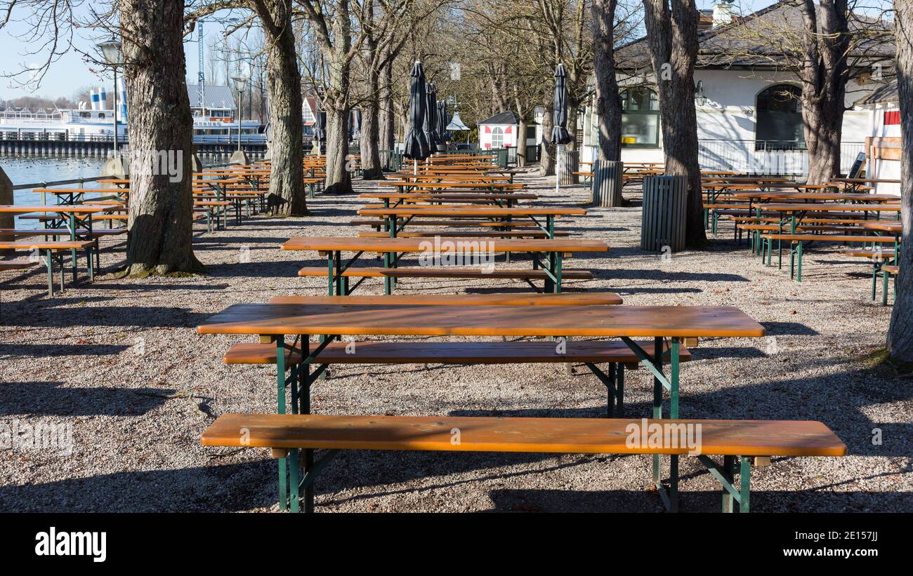 Stegen, Germany - Nov 27, 2020: View inside an empty beer garden. With many empty benches and tables. During Covid-19 lockdown. Stock Photo