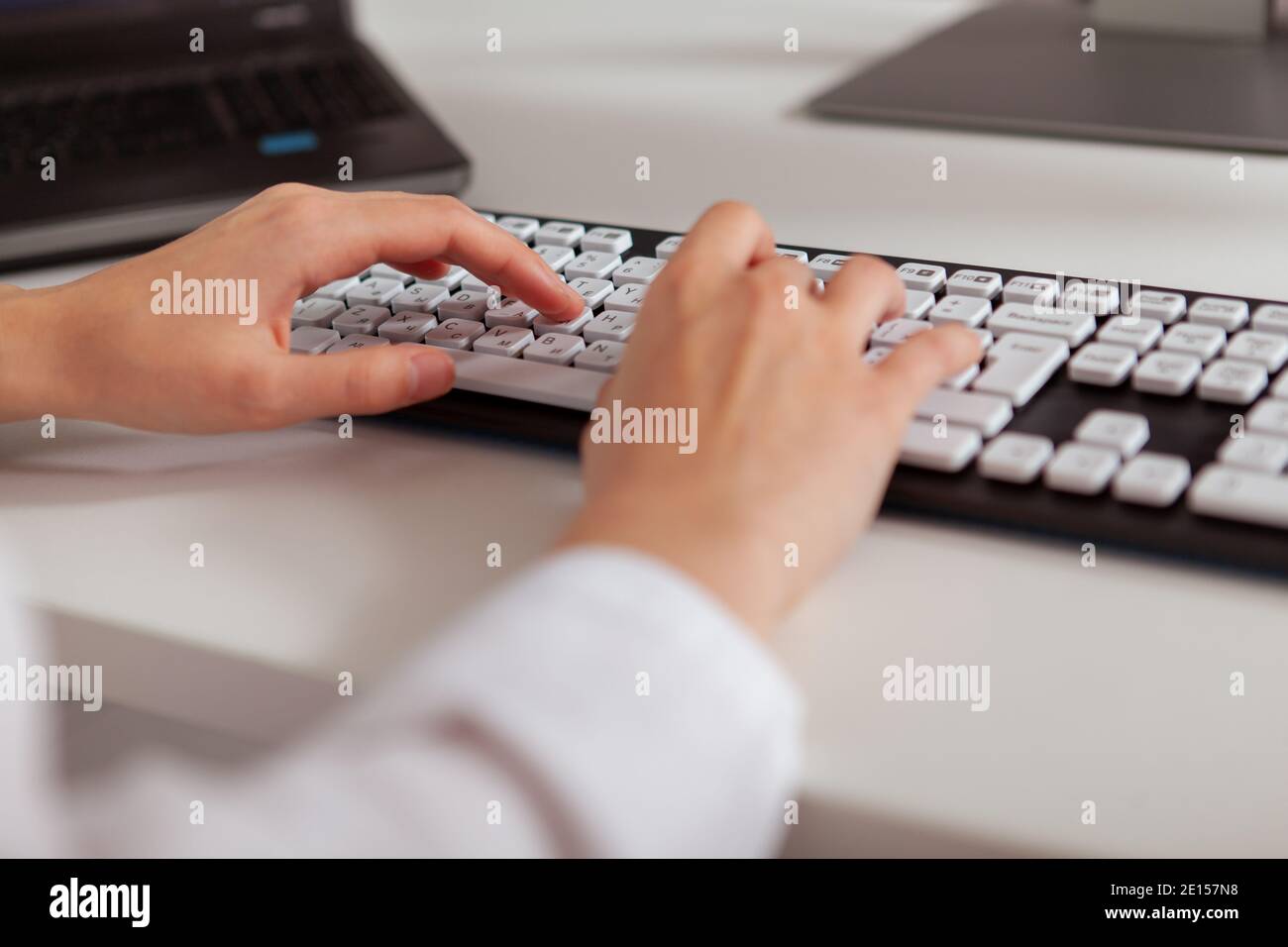 Close up of the hands of a businesswoman typing on computer keyboard Stock Photo