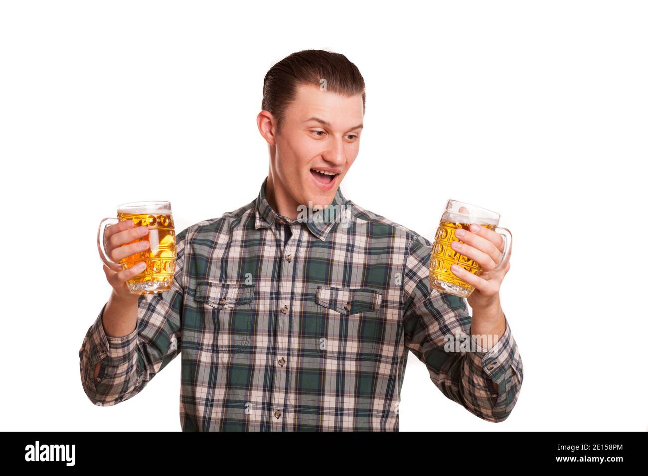 Handsome man looking excited holding two glasses of beer in his hands  isolated on white. Attractive happy man smiling joyfully, posing with drinks.  Re Stock Photo - Alamy