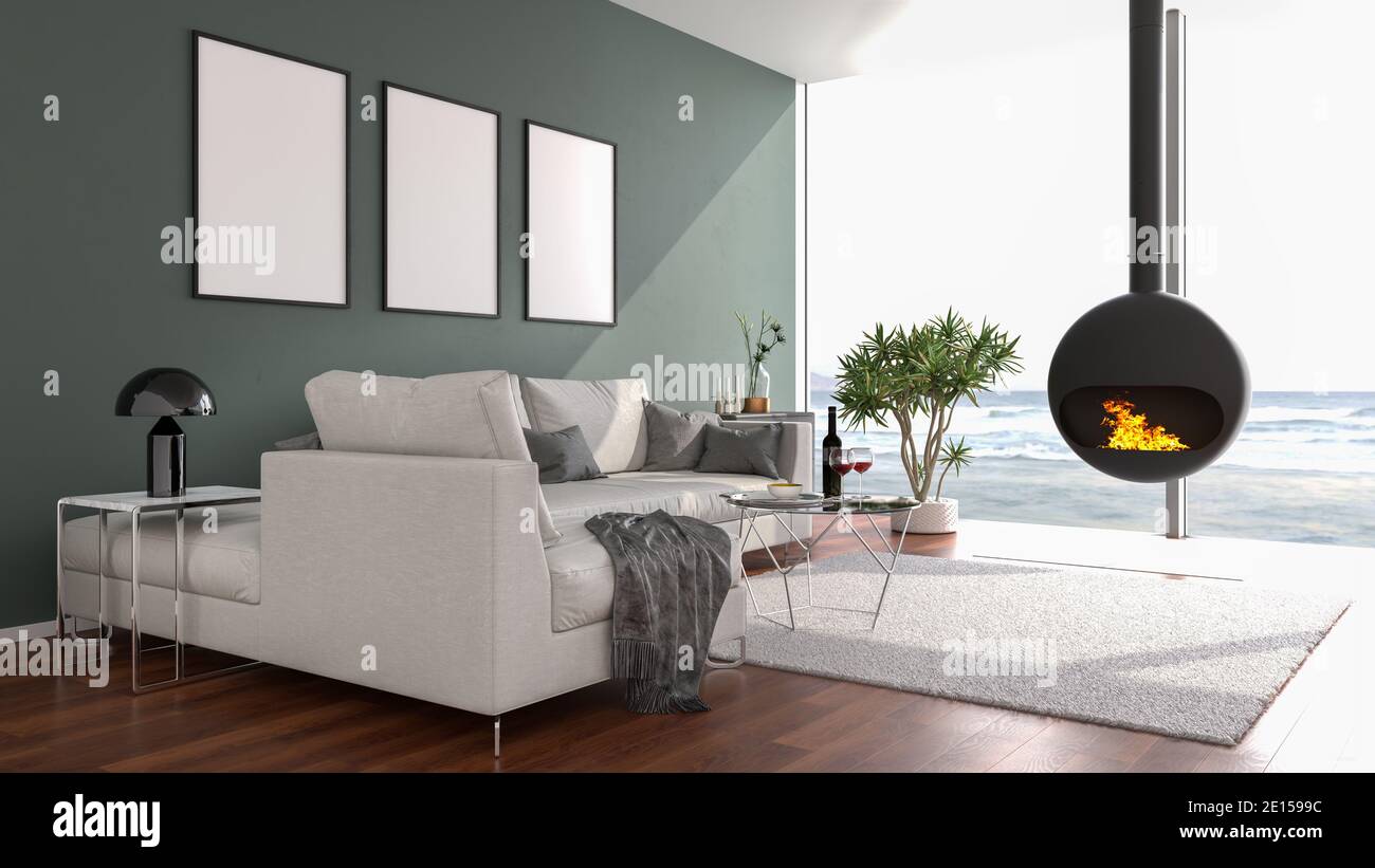 Modern loft style apartment with a stylish fireplace looking out to a beach through large floor-to-ceiling windows. Three picture frame mockups on the Stock Photo