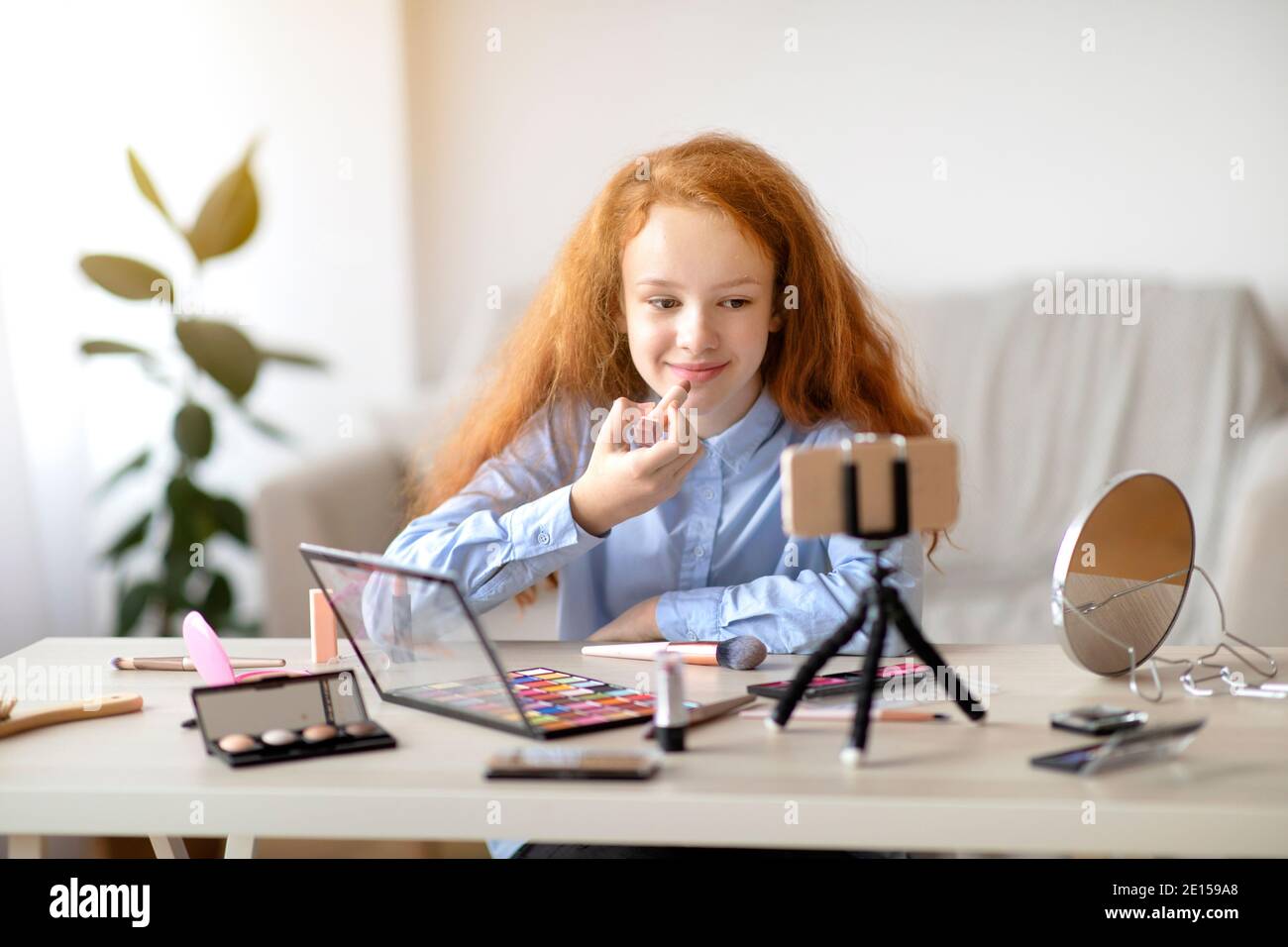 Teenager girl applying lipstick hi-res stock photography and images - Alamy