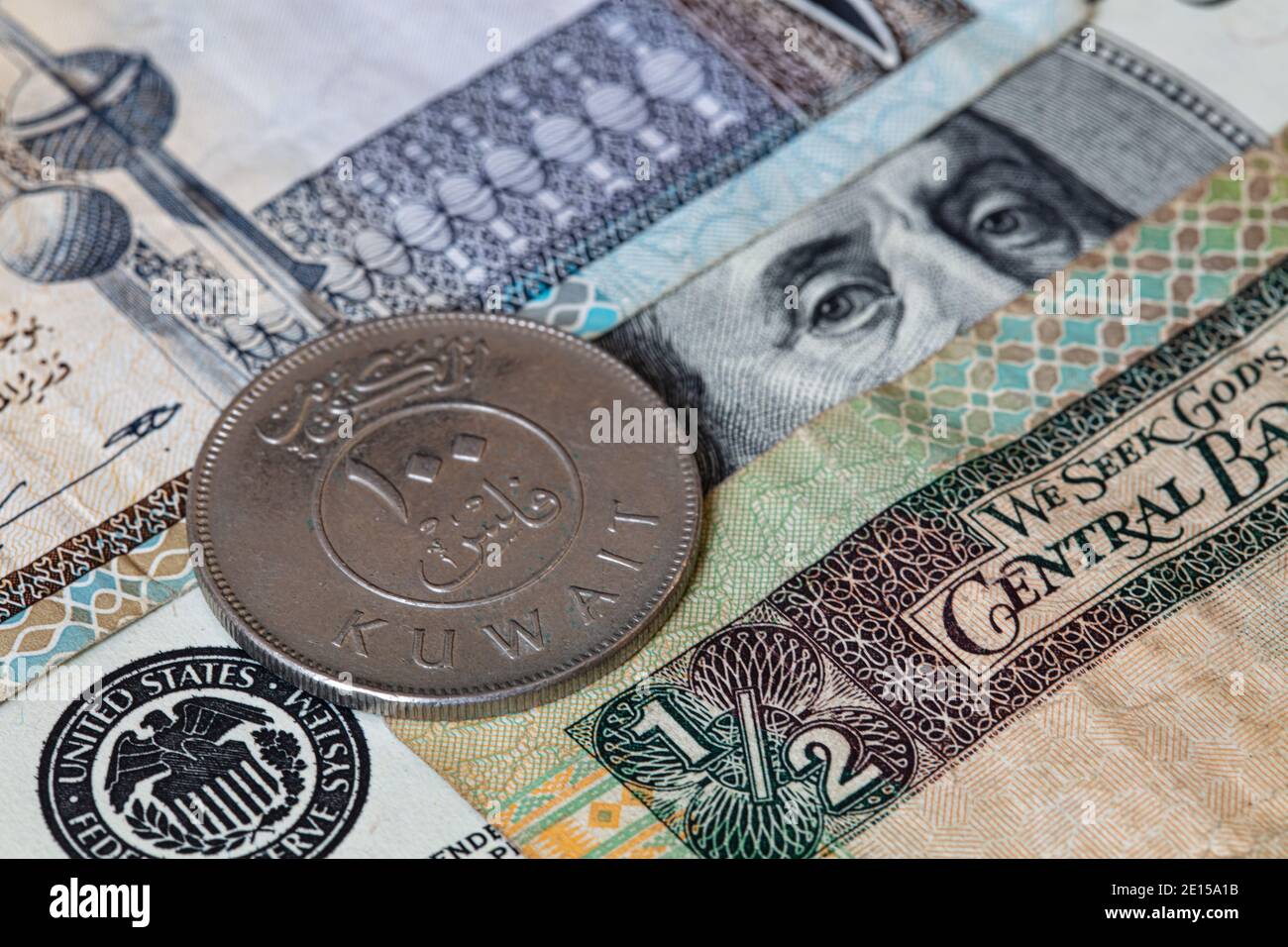 100 fils on 100 dollar and Kuwaiti Dinar banknotes background Stock Photo