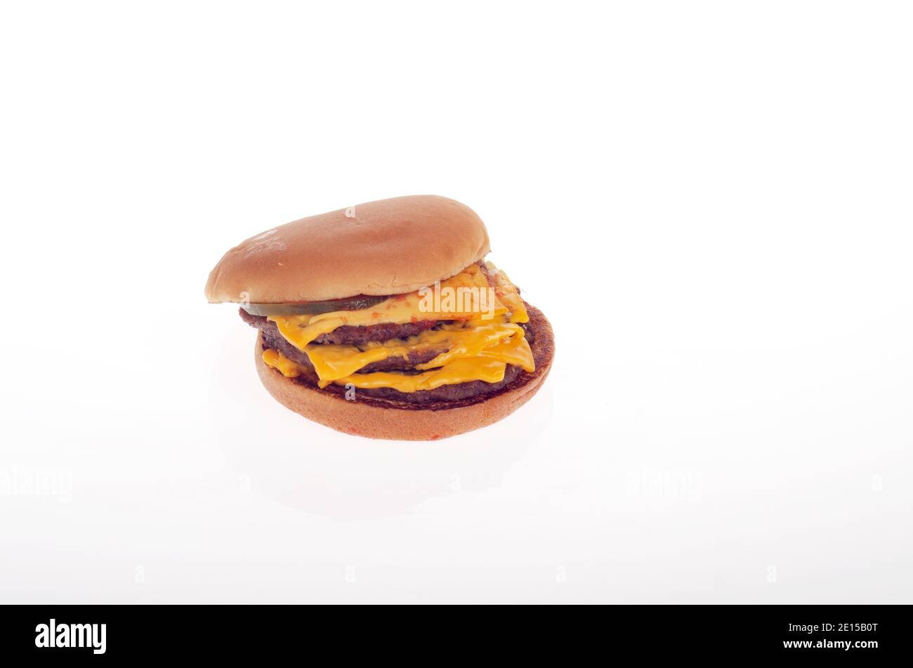 McDonalds Triple Cheeseburger on white background Stock Photo