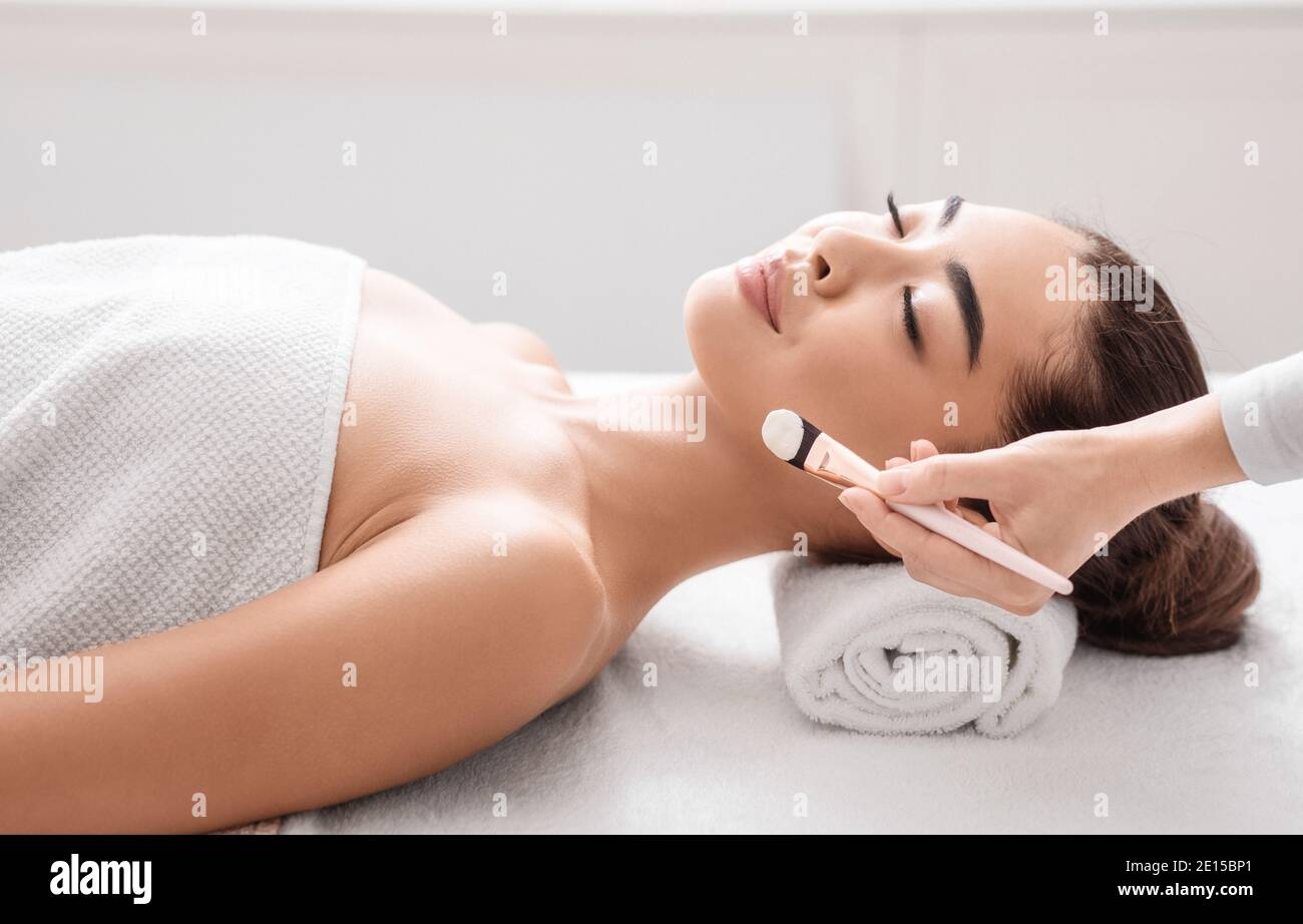 Skin Treatments. Young Korean Lady Enjoying Beauty Procedures In Spa Salon Stock Photo