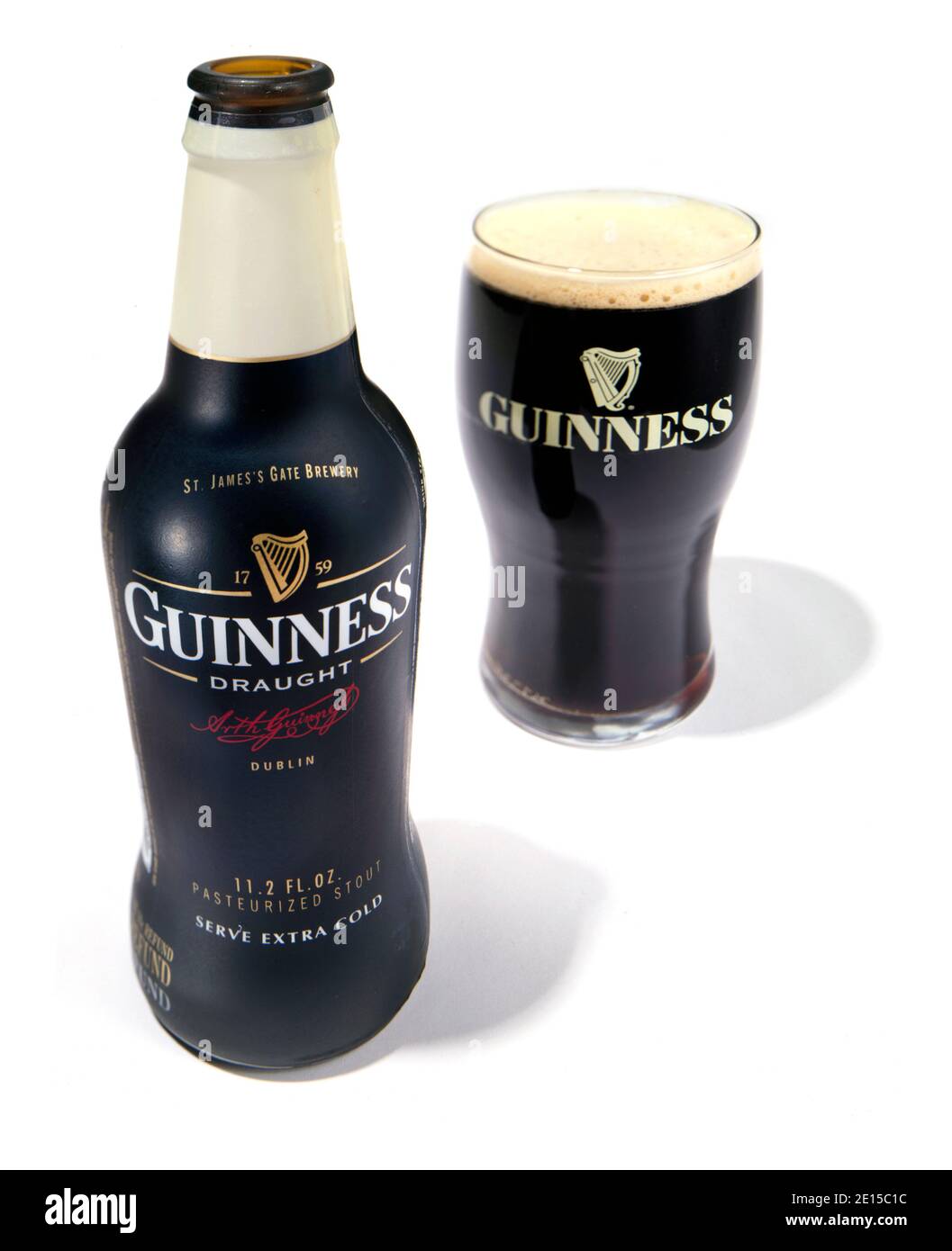 Guinness Beer Bottle And Glass Photographed On A White Background Stock Guinness Beer Bottle And Glass Photographed On A White Background Stock