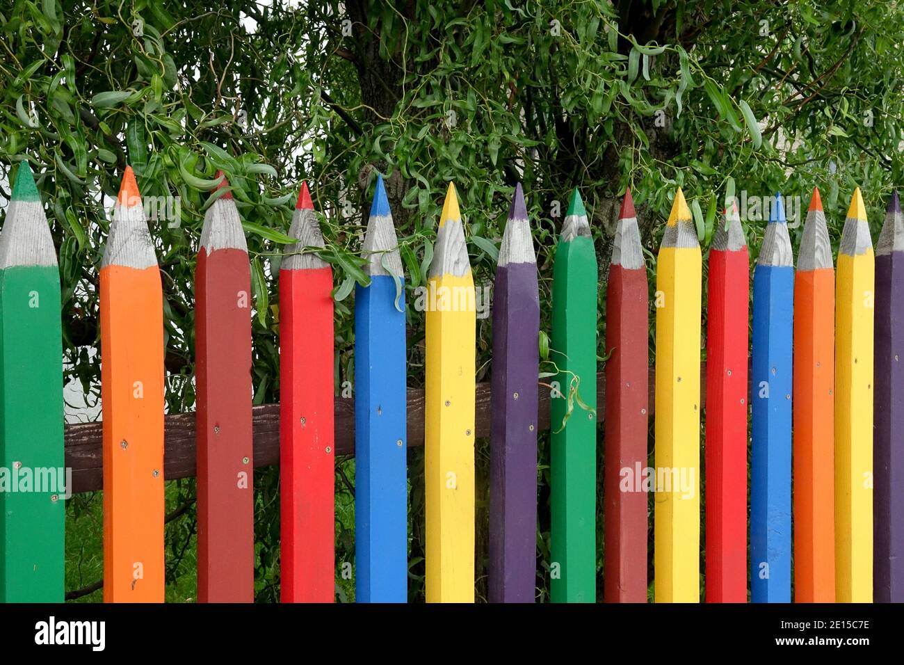 Colorful fence of pencils wooden fence garden Stock Photo