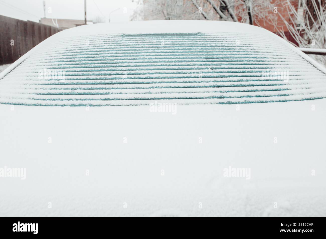 Ice melts on the rear window of the car - electric window heating 