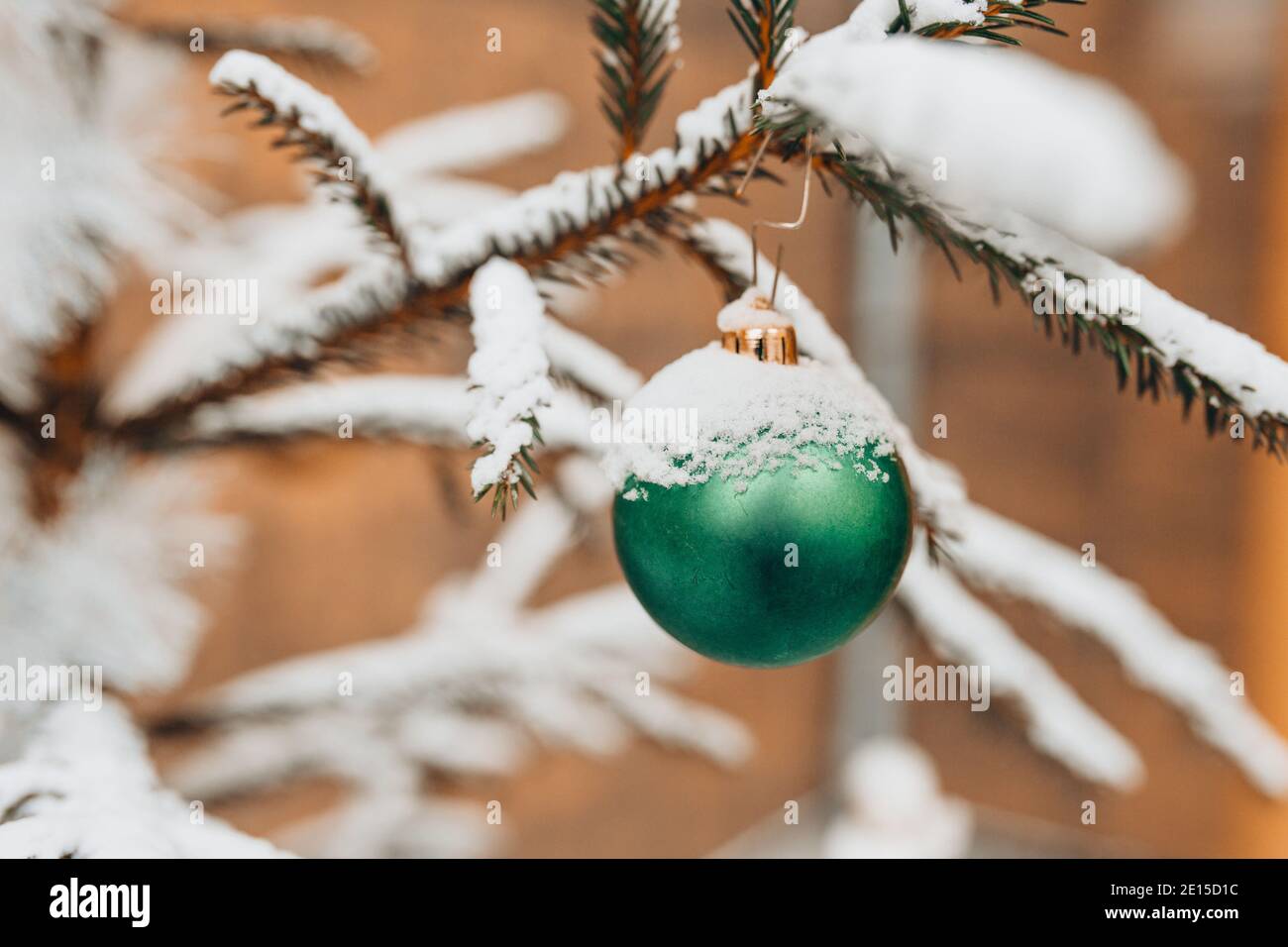 Shiny ball on a spruce branch - Christmas decoration of the Christmas tree Stock Photo