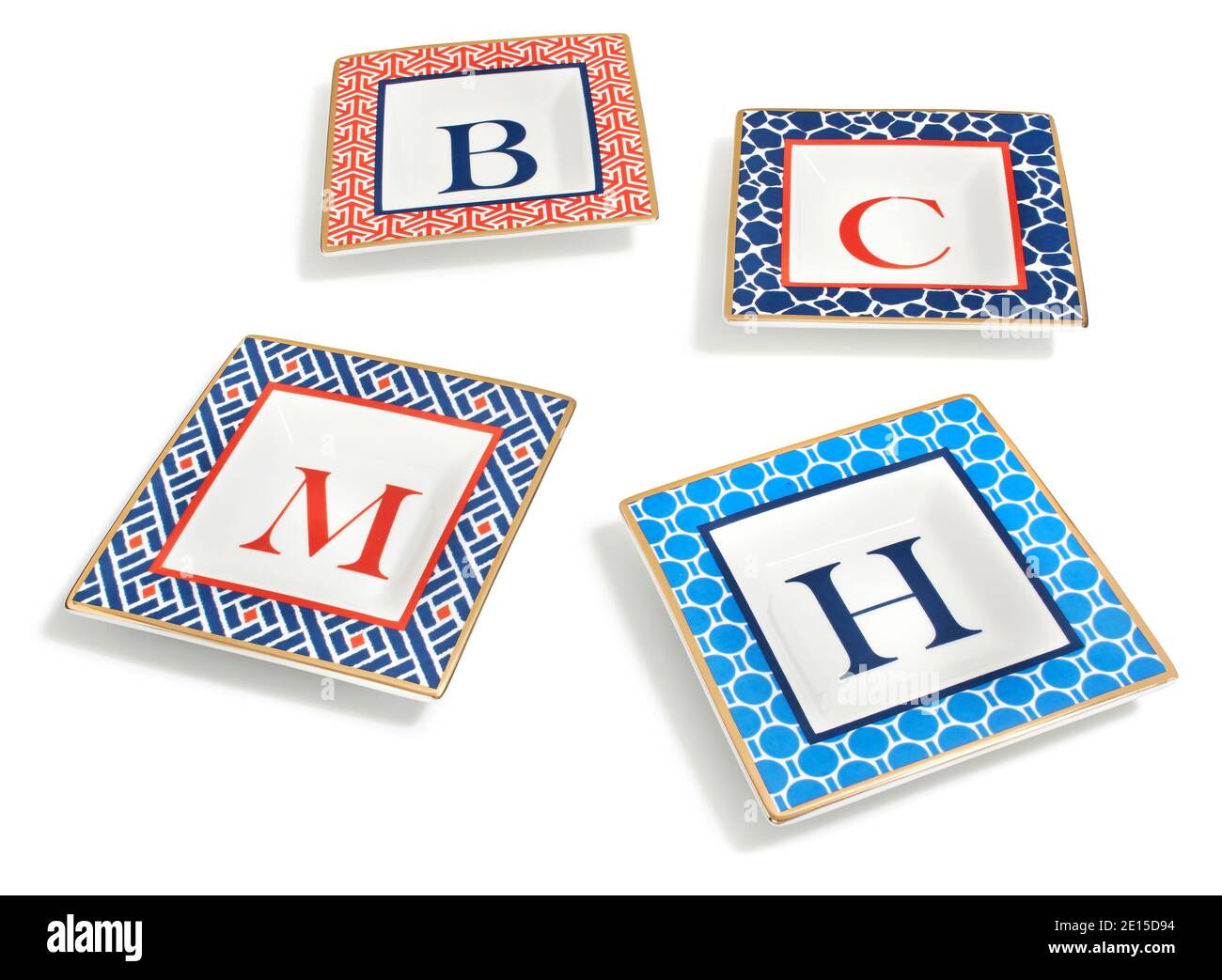 Blue and Red Monogrammed Dish Set with gold rim and patterned border from the FALL 2014 C.Wonder Look Book photographed on a white background. Stock Photo