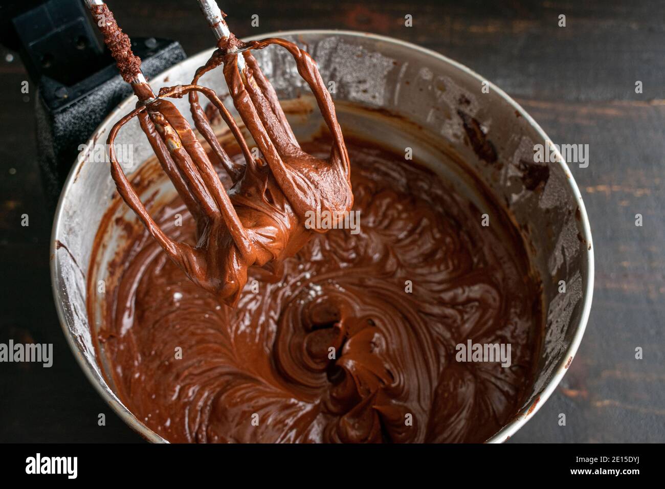 Making Chocolate Frosting in a Stand Mixer: Chocolate cake icing that has just been made in an electric stand mixer Stock Photo