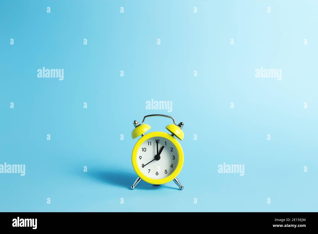 Mechanical alarm clock on the blue background Stock Photo - Alamy