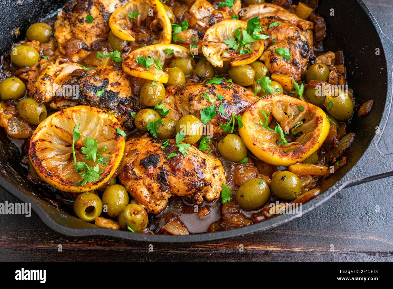 Moroccan Lemon Olive Chicken Chicken thighs, olives, and lemons cooked in a cast iron skillet